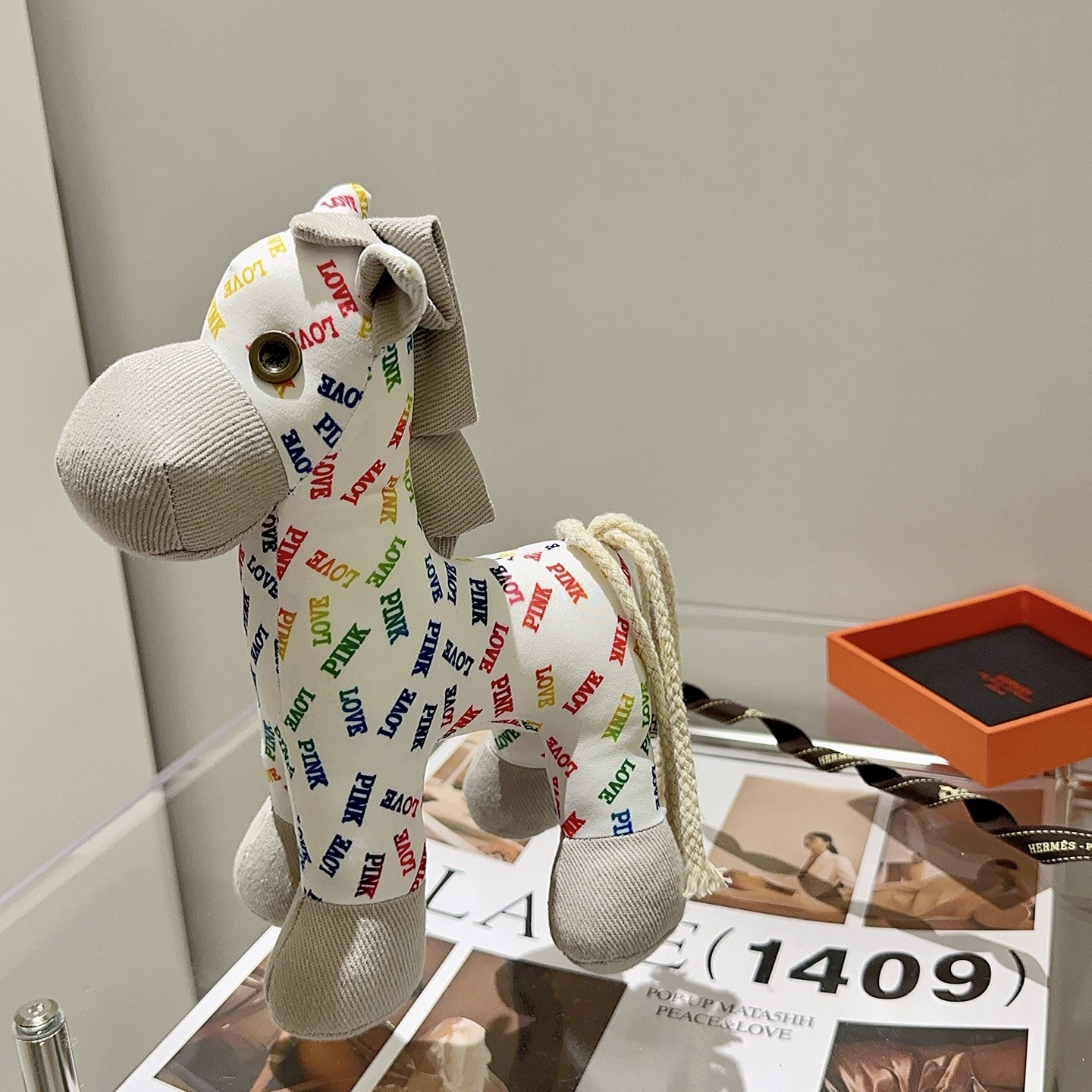 Hermes Rodeo Pegase Horse Charm pendant White fabric with multicolor LOVE and PINK text print light gray corduroy accents cream rope tail brass-toned metal eye detail 25cm