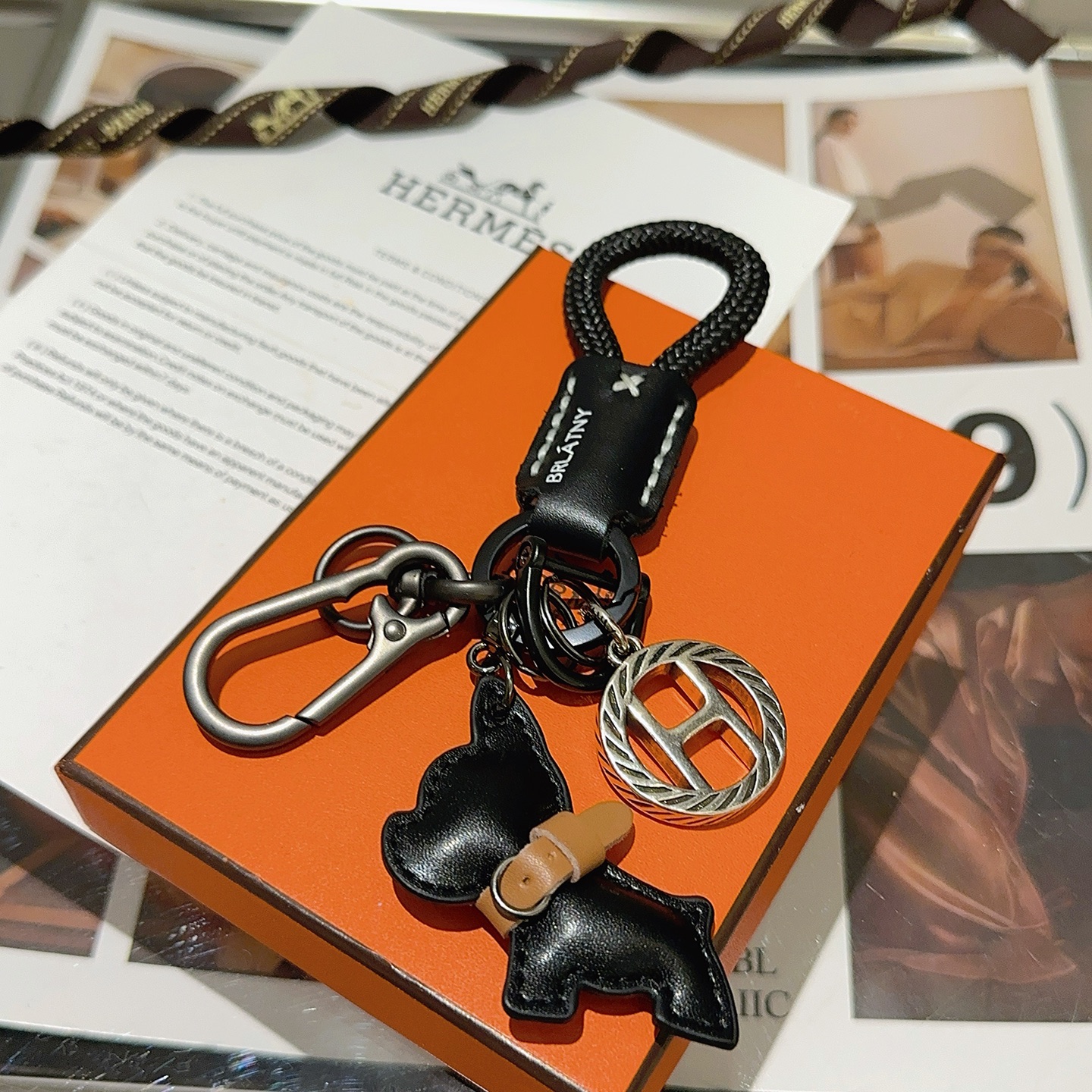 Hermes H Logo Bulldog Charm Keychain pendant gunmetal silver metal black braided cord black leather tan leather accent 10cm total length