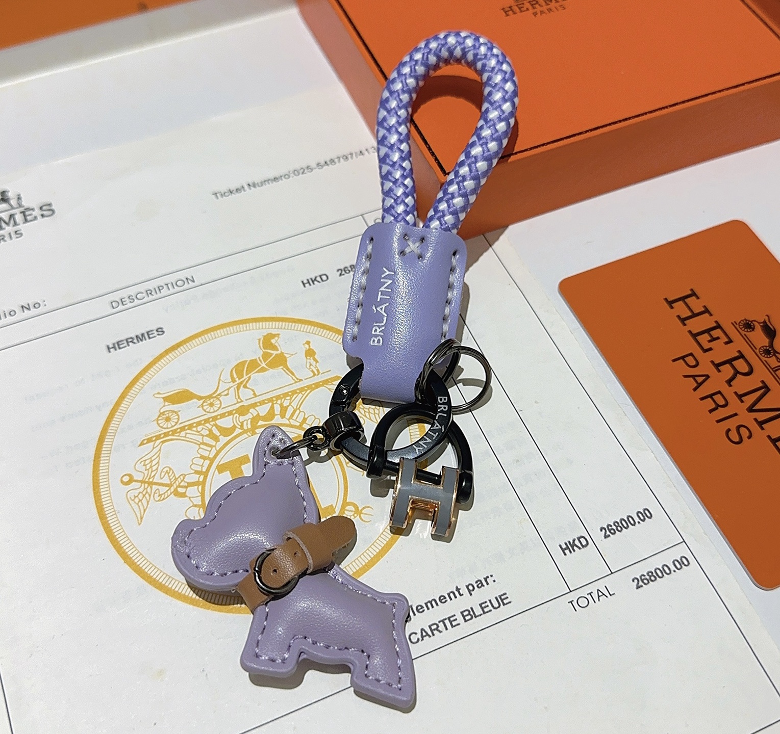 Hermes H Logo Bulldog Charm Porte-clés pendentif Cuir violet lavande accent cuir marron cordon tressé violet et blanc bronze à canon matériel noir or rose et gris Breloque logo H 10 cm longueur totale