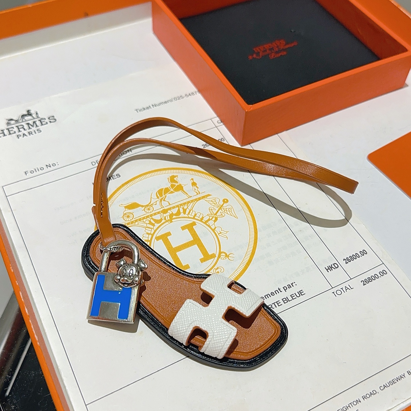 Hermes Oran Sandal Charm pendant tan leather white Epsom leather silver-tone metal blue enamel black edge trim 12cm strap length