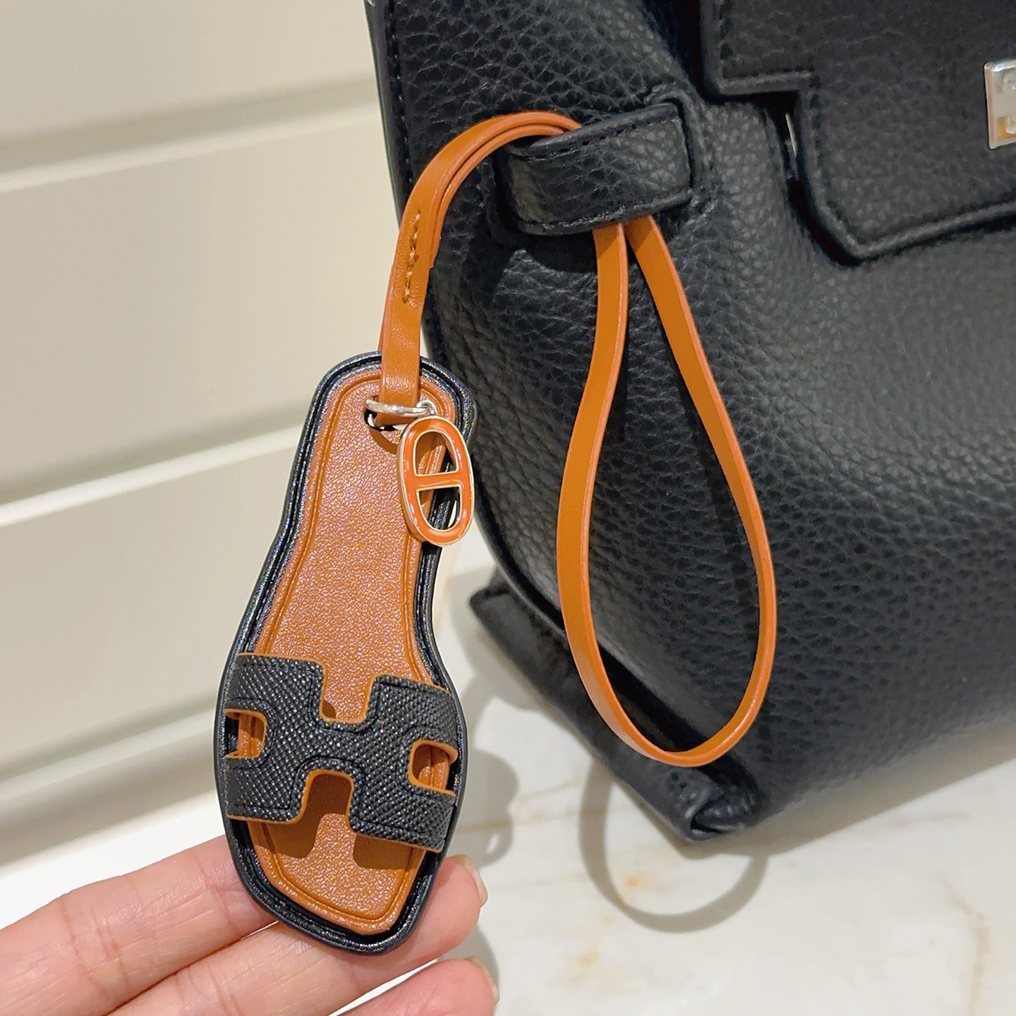 Hermes Oran Sandal Bag Charm pendant tan leather black grained leather orange enamel silver metal 18cm strap length
