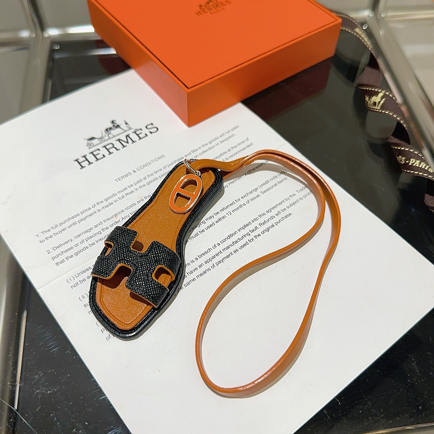 Hermes Oran Sandal Bag Charm pendant tan leather black grained leather orange enamel silver metal 18cm strap length