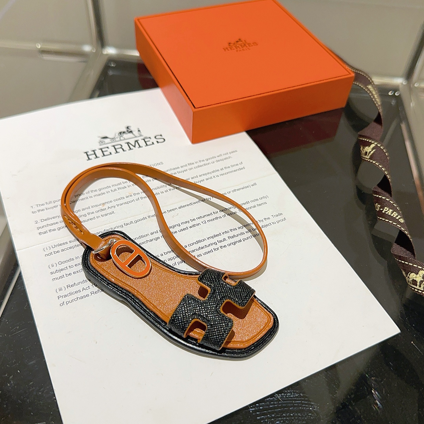 Hermes Oran Sandal Bag Charm pendant tan leather black grained leather orange enamel silver metal 18cm strap length