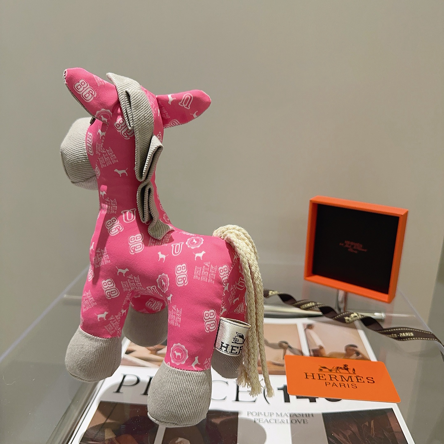 Hermes Hermes Plush Horse Charm pendant Pink fabric with white print light gray fabric accents cream rope tail brass-toned metal eye detail 35cm