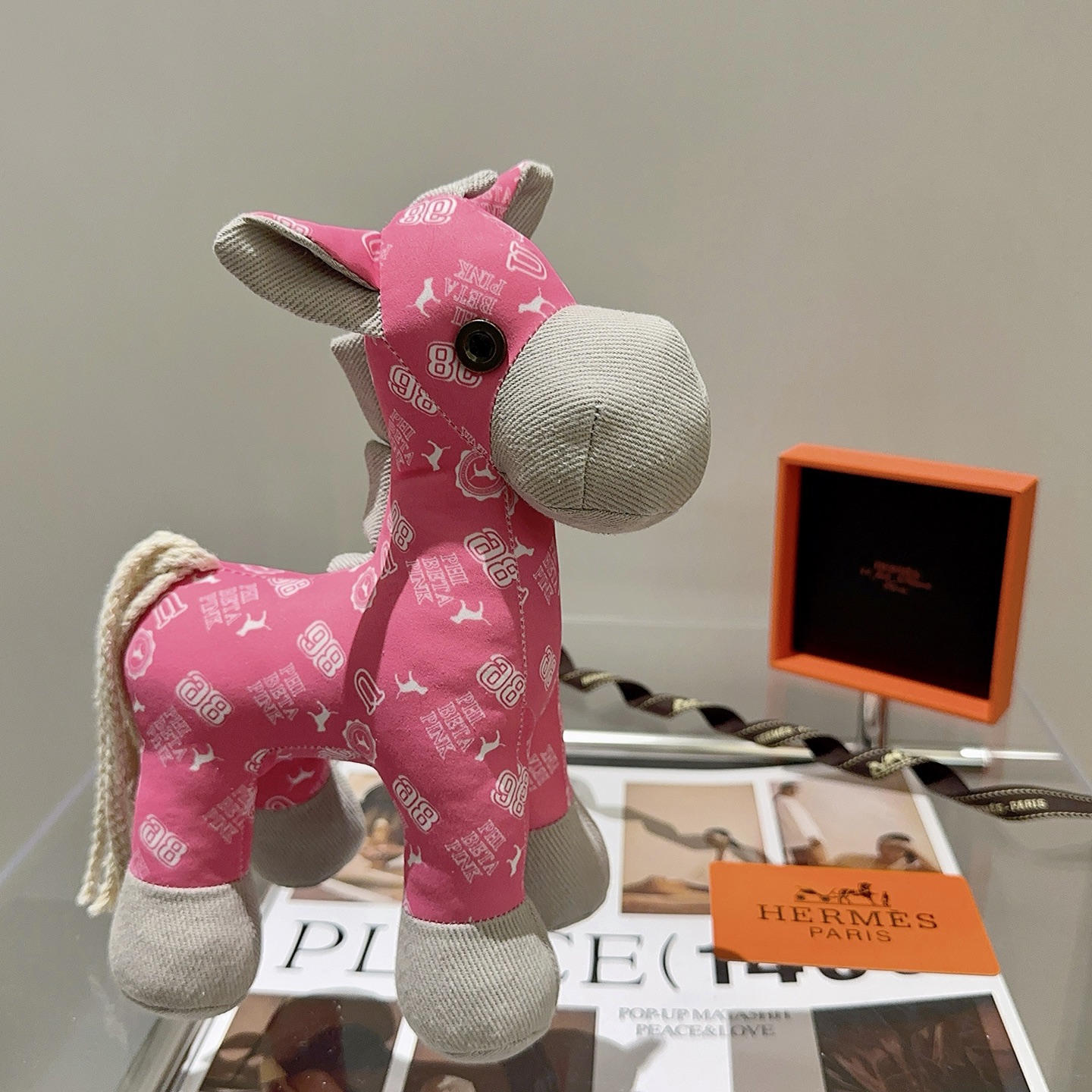 Hermes Hermes Plush Horse Charm pendant Pink fabric with white print light gray fabric accents cream rope tail brass-toned metal eye detail 35cm