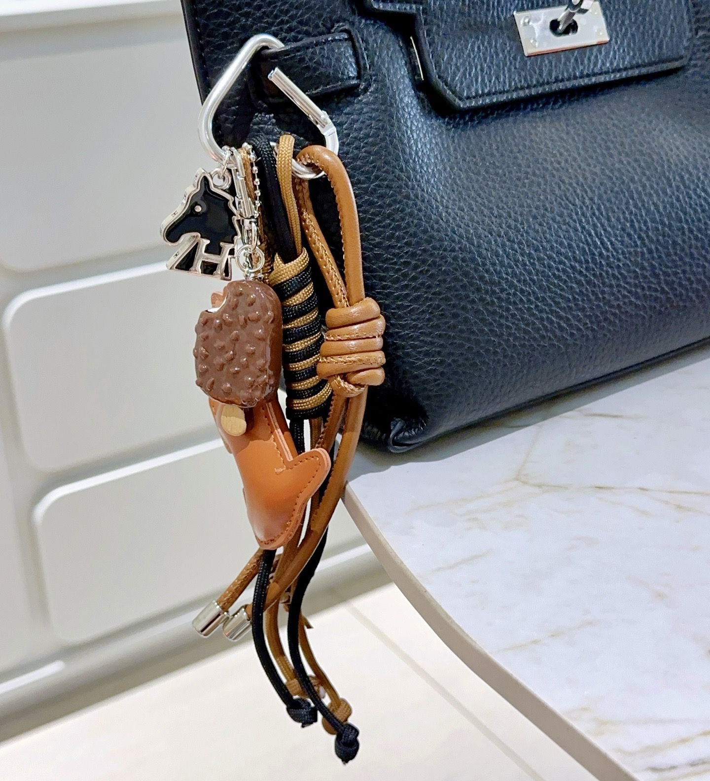 Hermes Scottie Dog Charm Keychain pendant tan leather silver-tone metal black enamel brown and beige dessert-themed charms black and tan woven cord 15cm total strap length
