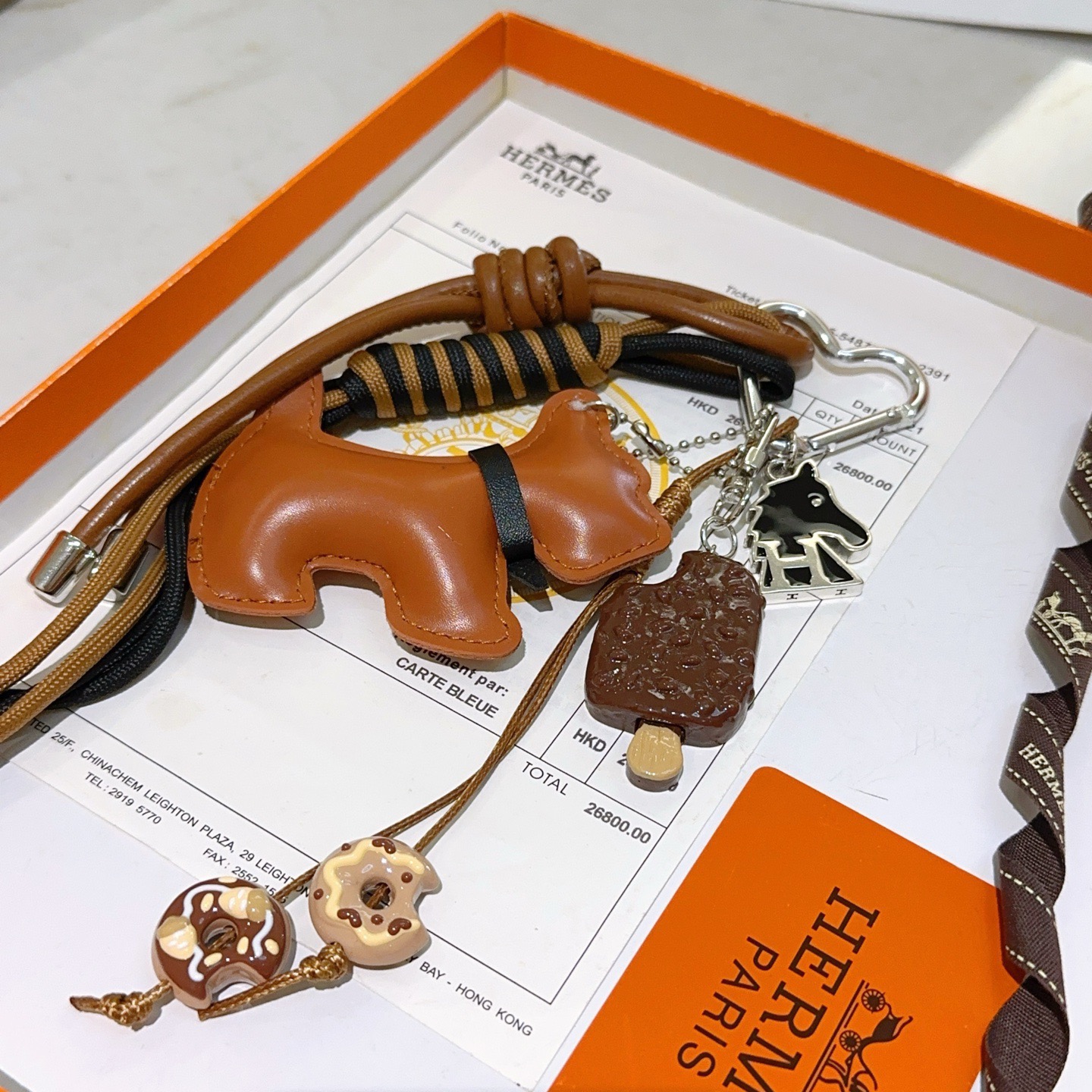 Hermes Scottie Dog Charm Keychain pendant tan leather silver-tone metal black enamel brown and beige dessert-themed charms black and tan woven cord 15cm total strap length