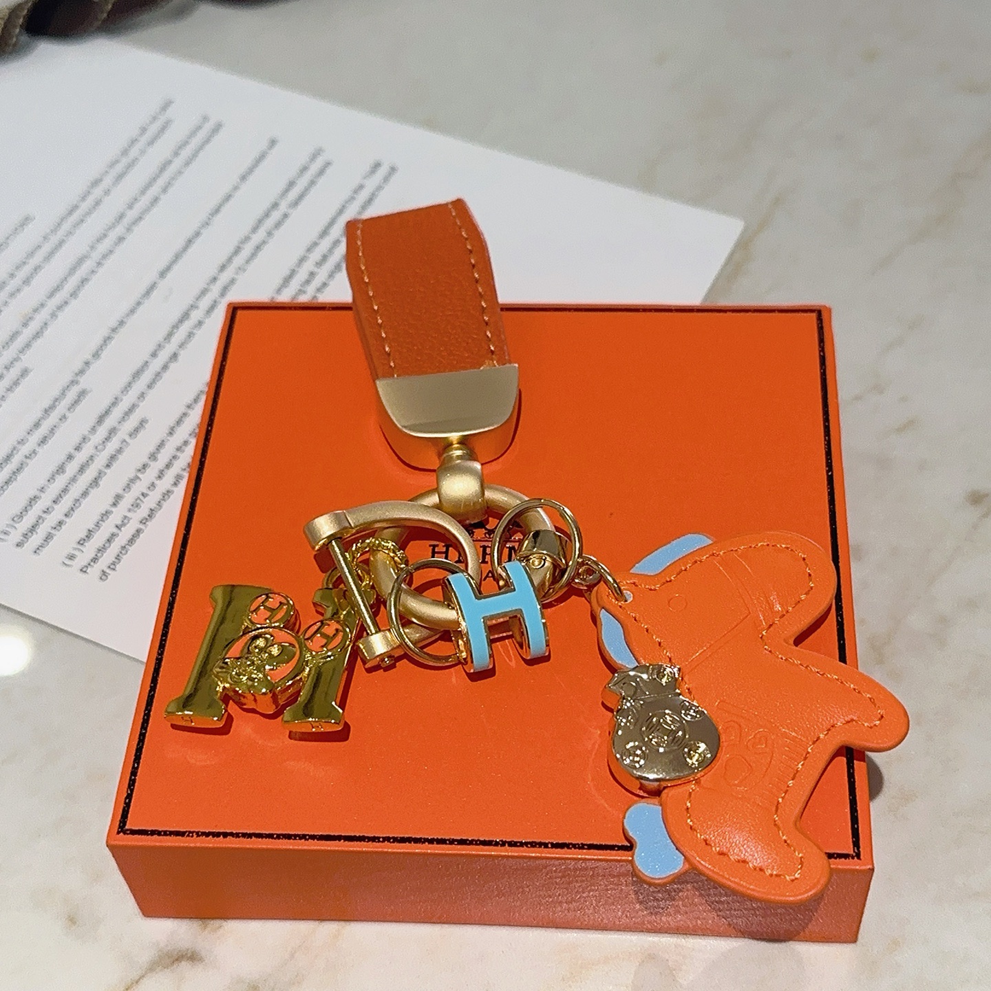 Hermes Rodeo Horse Charm Keychain pendant Orange leather with light blue accents gold-tone metal hardware 10cm total length