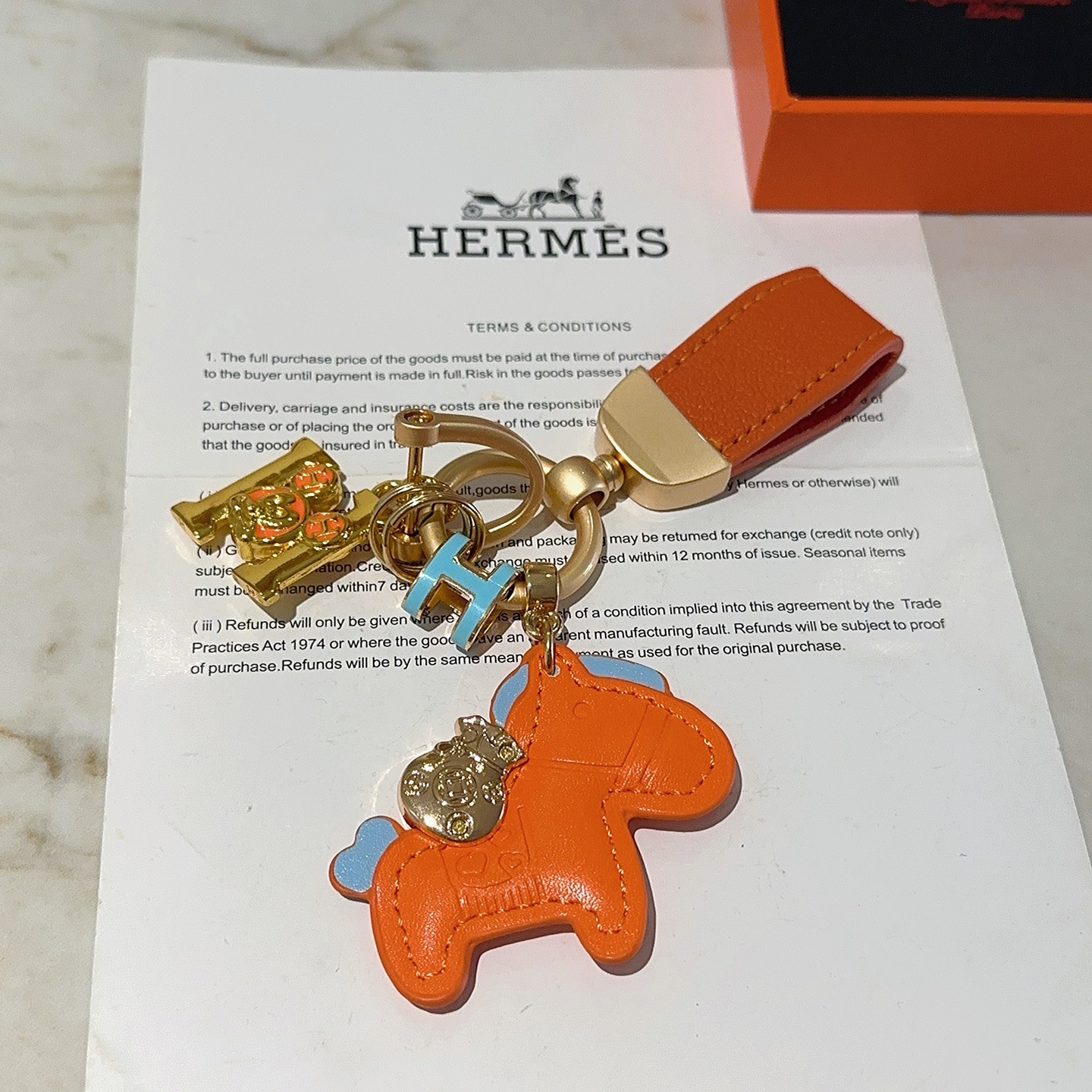 Hermes Rodeo Horse Charm Keychain pendant Orange leather with light blue accents gold-tone metal hardware 10cm total length