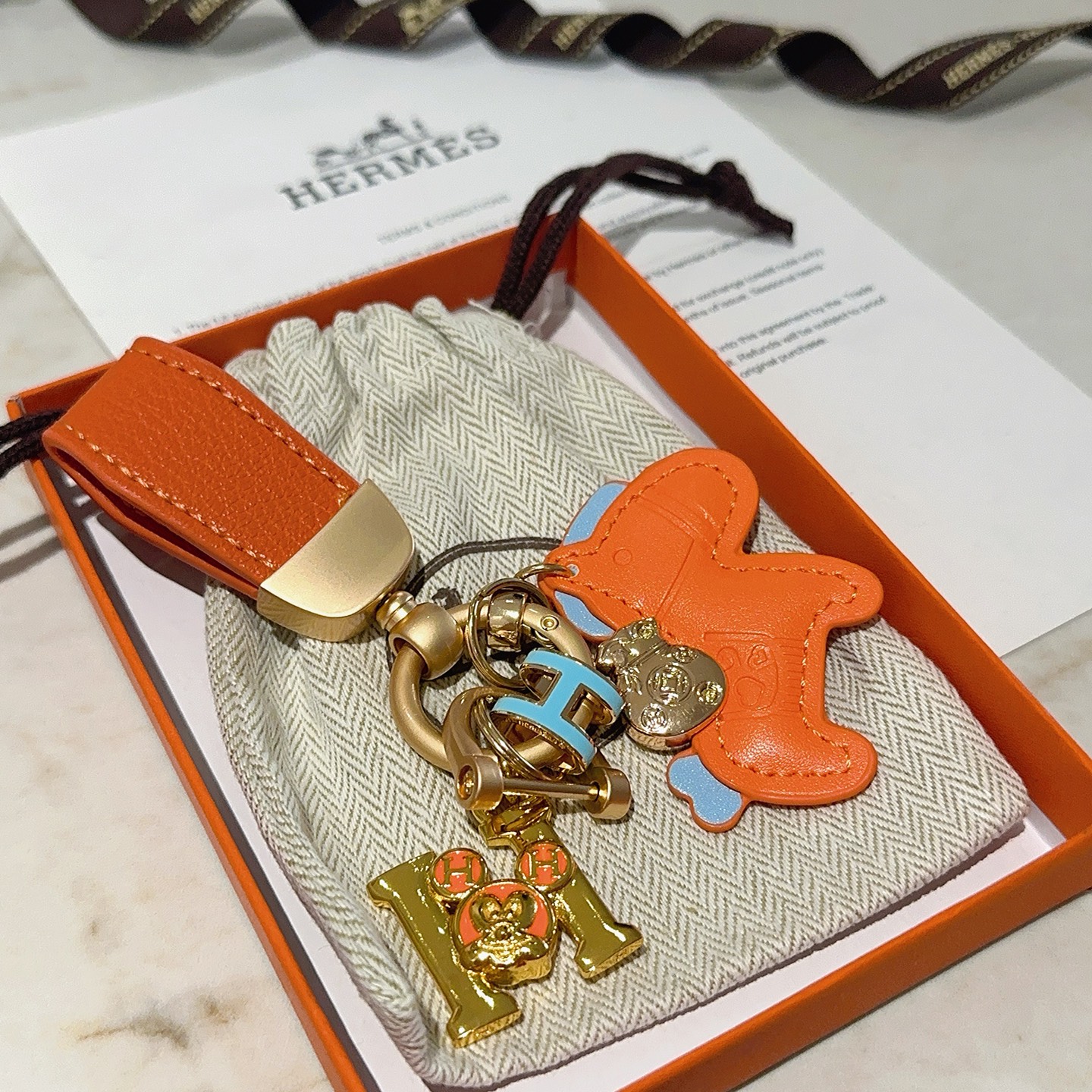 Hermes Rodeo Horse Charm Keychain pendant Orange leather with light blue accents gold-tone metal hardware 10cm total length