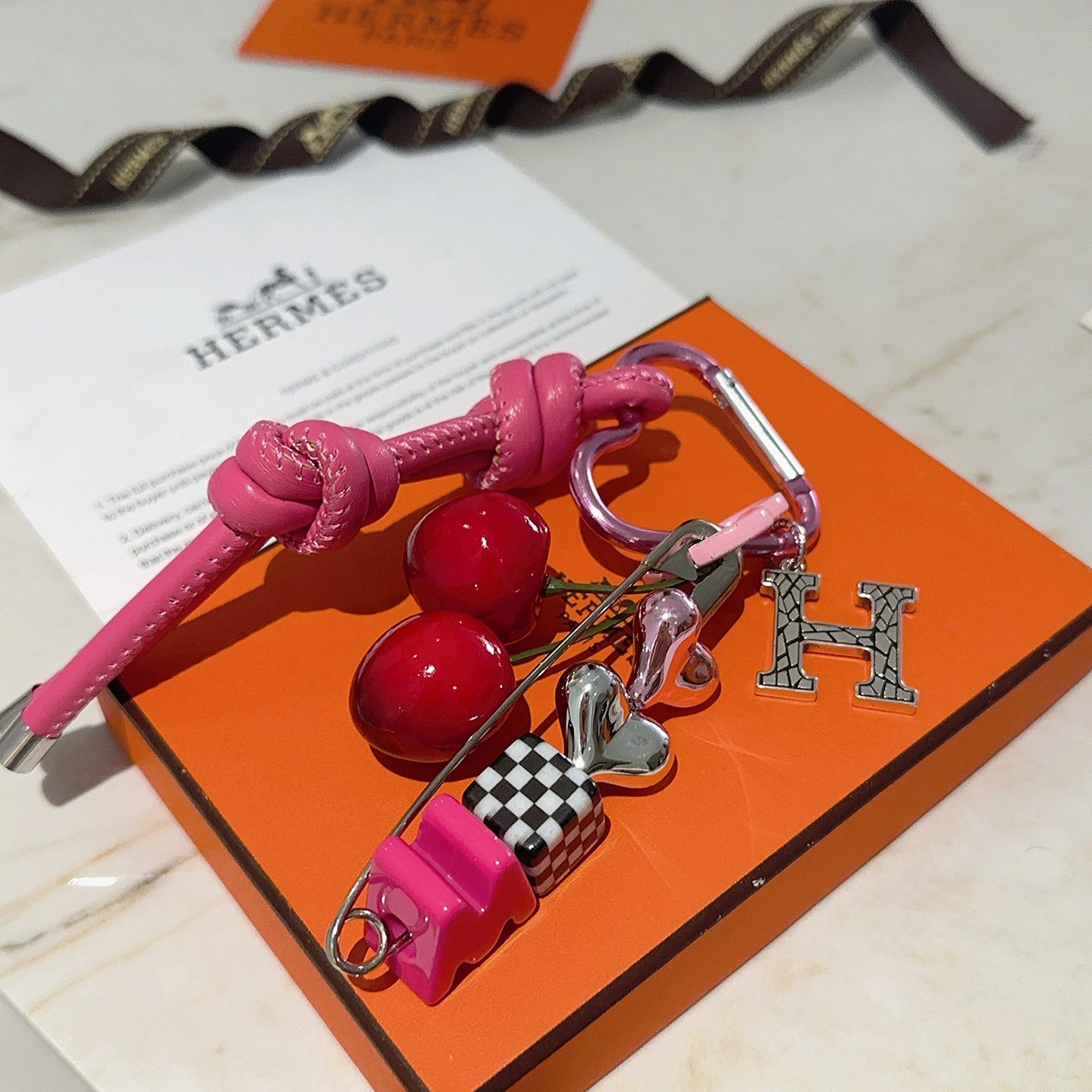 Hermes Cherry H Logo Knot Bag Charm Keychain pendant Hot pink leather silver-tone metal red cherry accents black and white checkered detail pink heart hardware green cherry stems 10cm