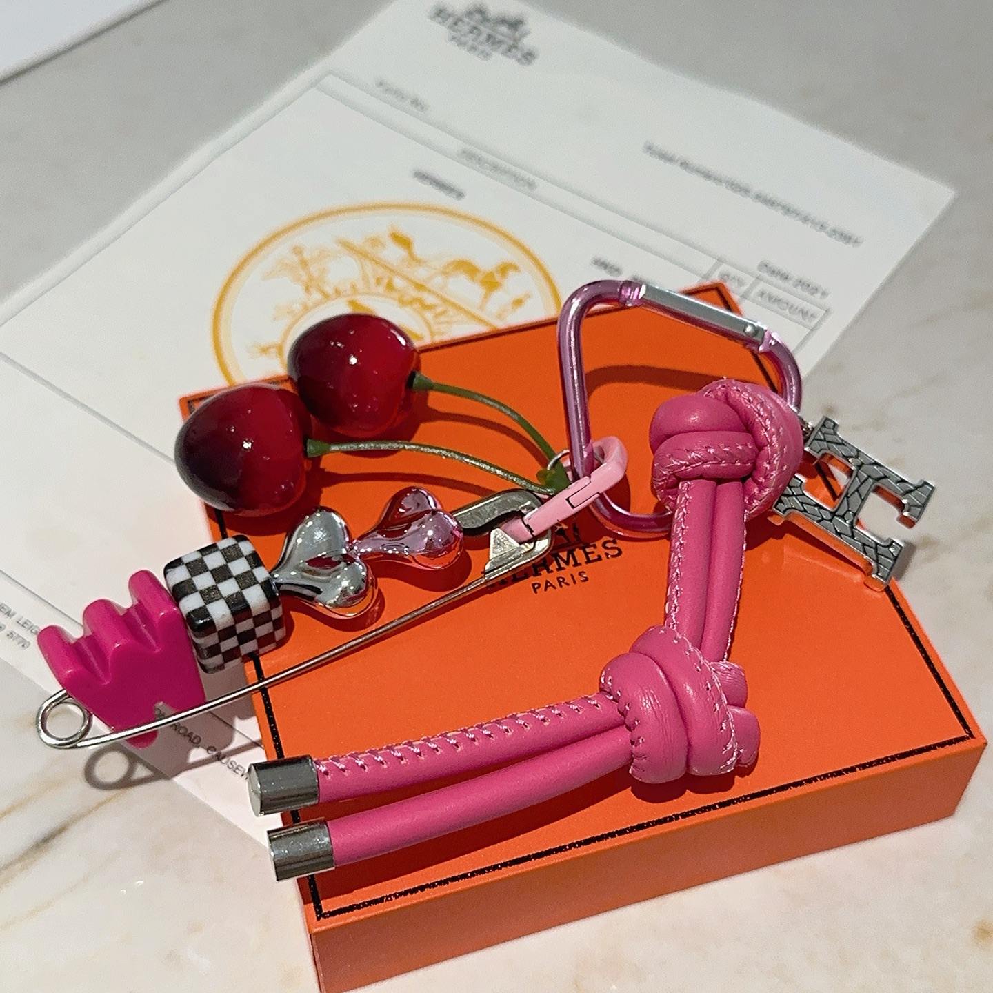 Hermes Cherry H Logo Knot Bag Charm Keychain pendant Hot pink leather silver-tone metal red cherry accents black and white checkered detail pink heart hardware green cherry stems 10cm