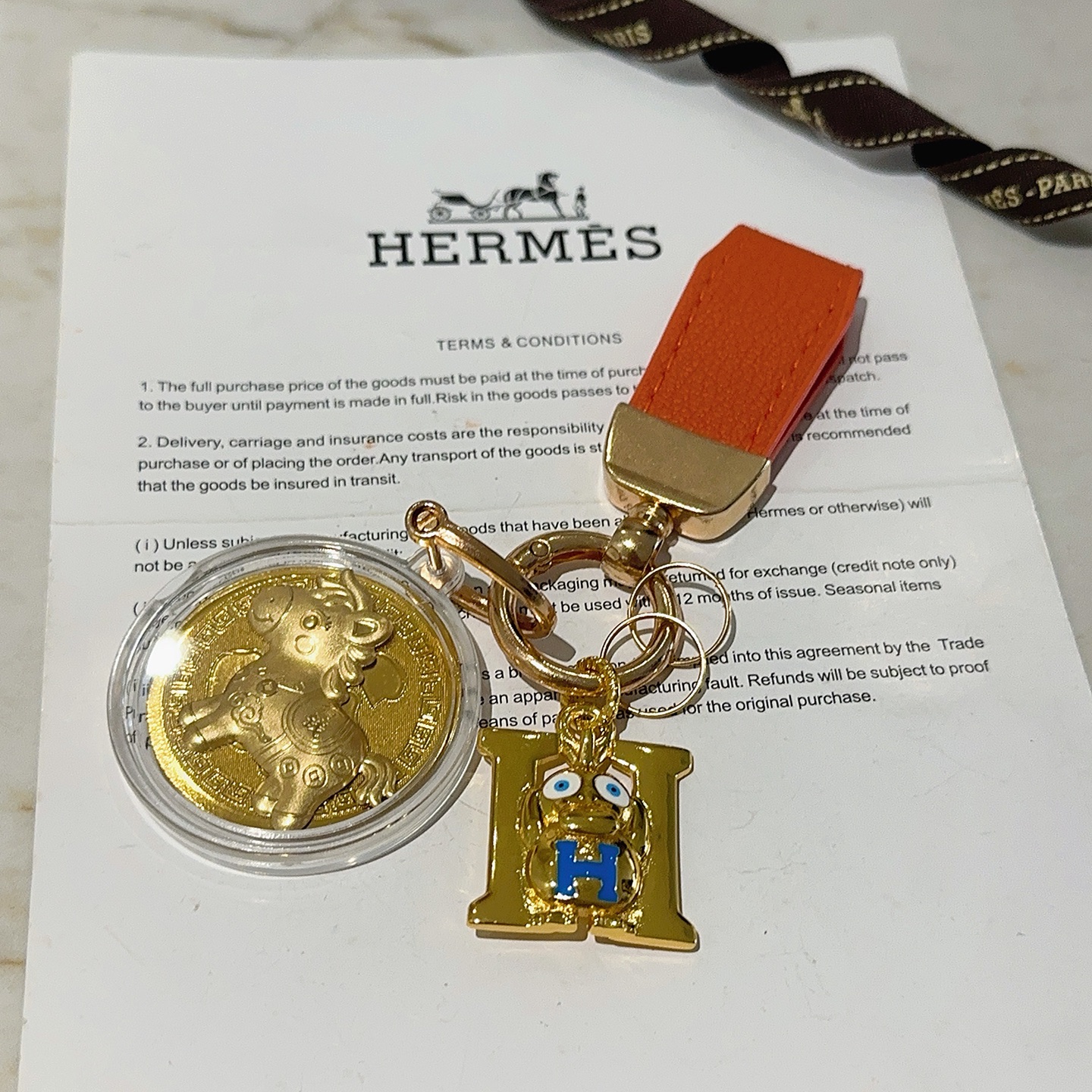 Hermes H Logo Horse Medallion Keychain pendant Orange leather gold-tone metal blue enamel gold medallion 10cm total length