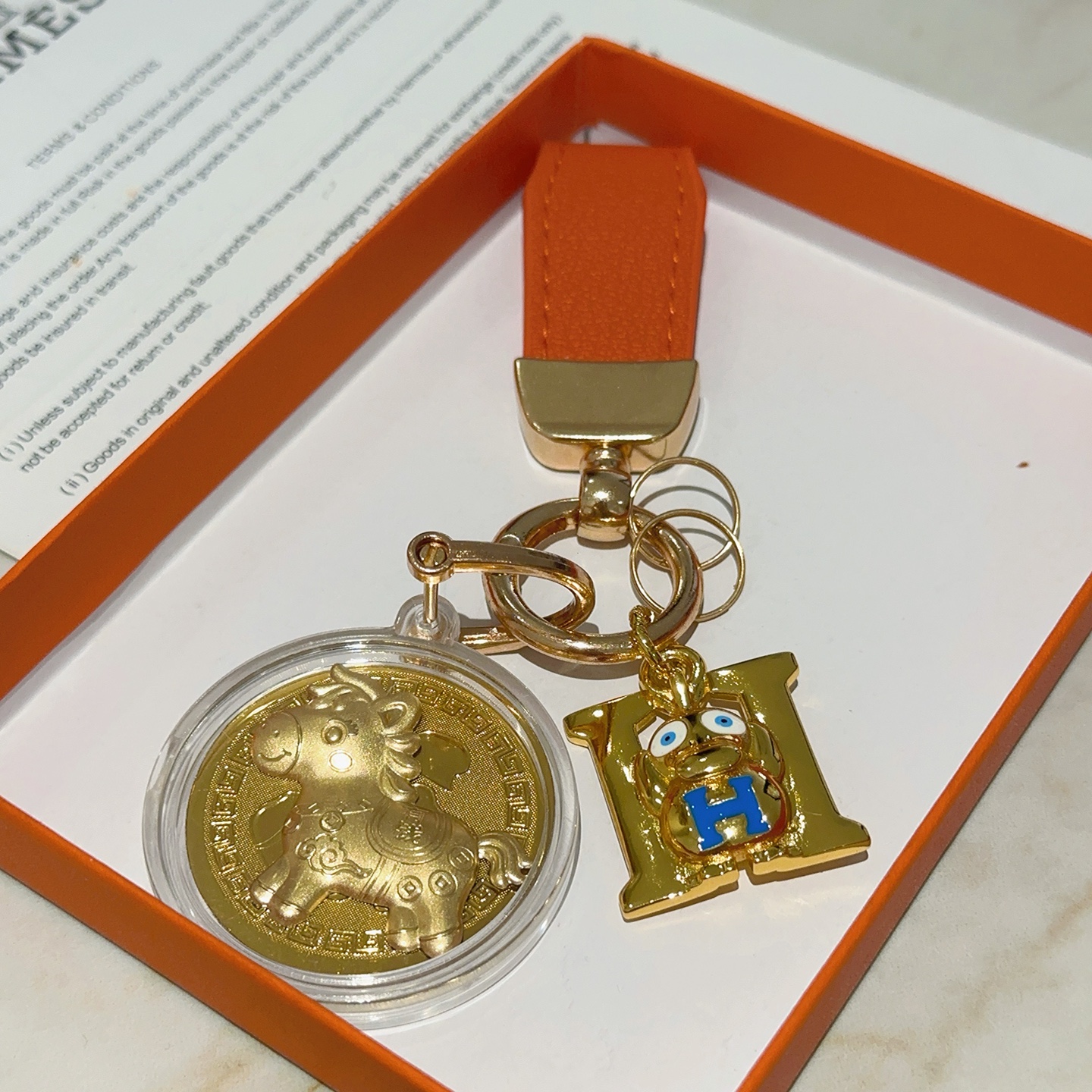Hermes H Logo Horse Medallion Keychain pendant Orange leather gold-tone metal blue enamel gold medallion 10cm total length