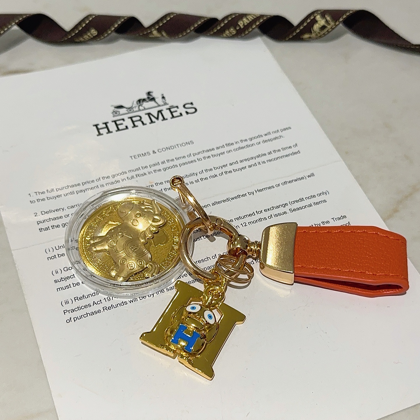 Hermes H Logo Horse Medallion Keychain pendant Orange leather gold-tone metal blue enamel gold medallion 10cm total length