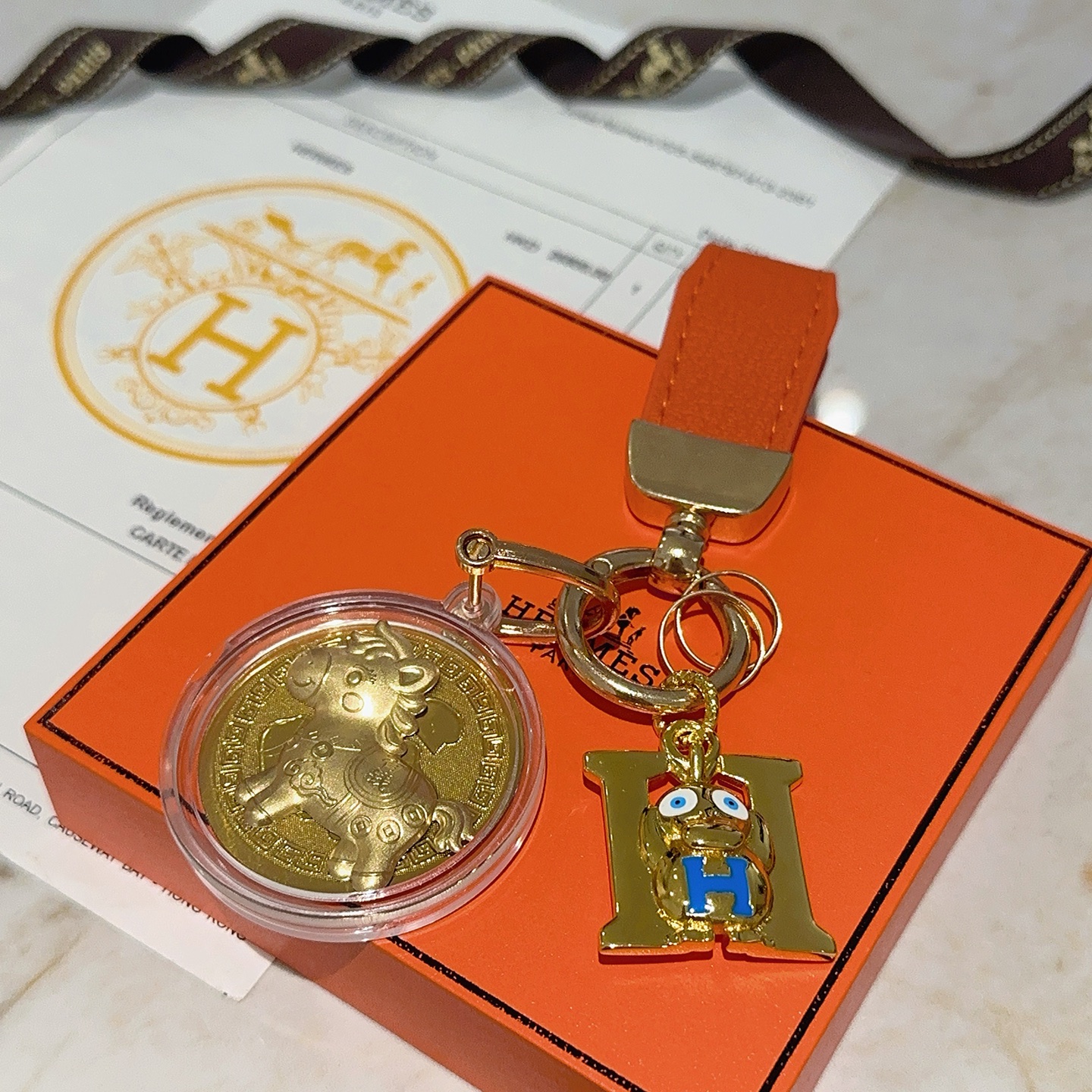 Hermes H Logo Horse Medallion Keychain pendant Orange leather gold-tone metal blue enamel gold medallion 10cm total length