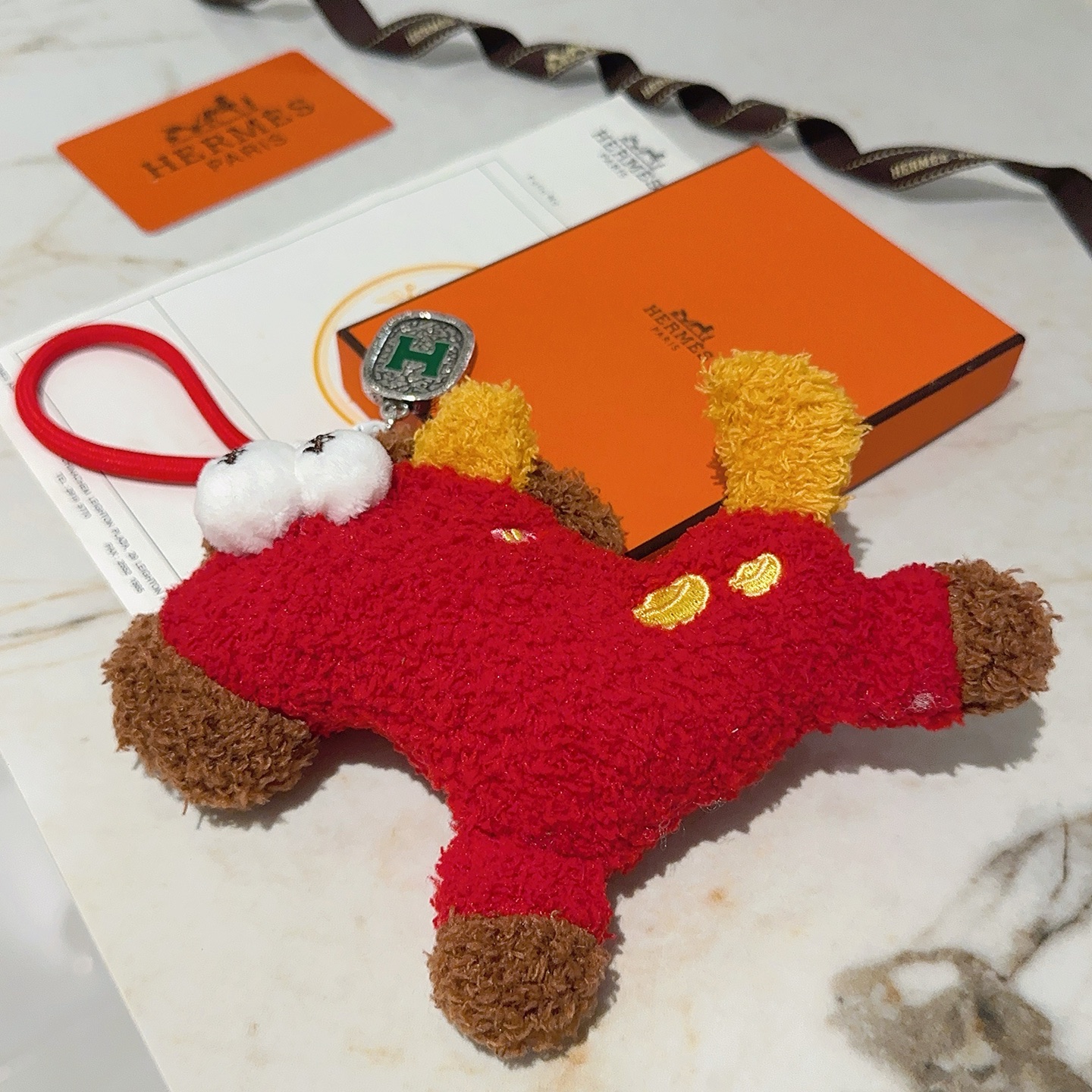 Hermes H Logo Plush Charm pendant Red plush with brown yellow white fabric accents silver-toned metal with green enamel H detail 12cm