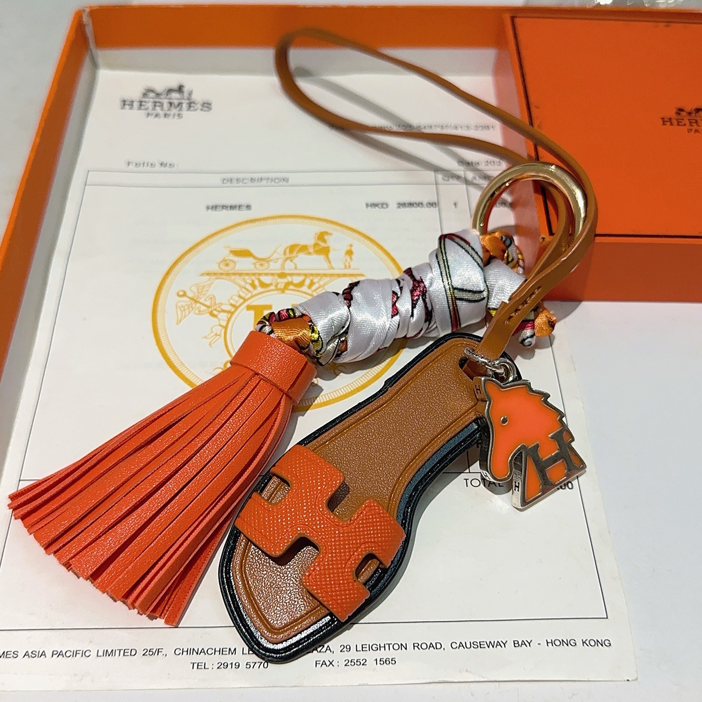 Hermes Oran Sandal Tassel Bag Charm pendant Orange leather tan leather black trim silver-tone metal multicolor printed silk gold-tone hardware 12cm total length