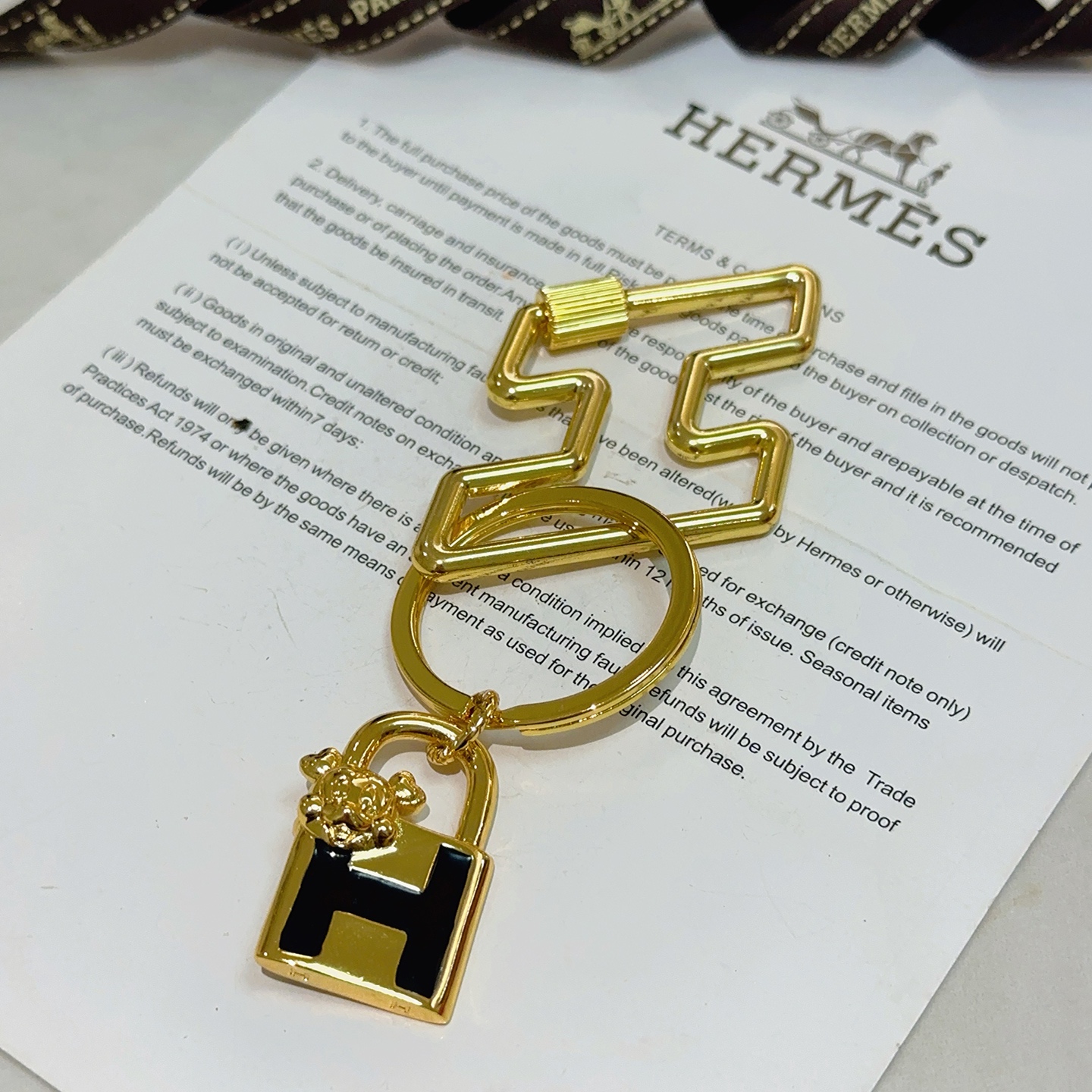 Hermes H Lock Bulldog Charm Keychain pendant gold tone metal with black enamel 8cm total length