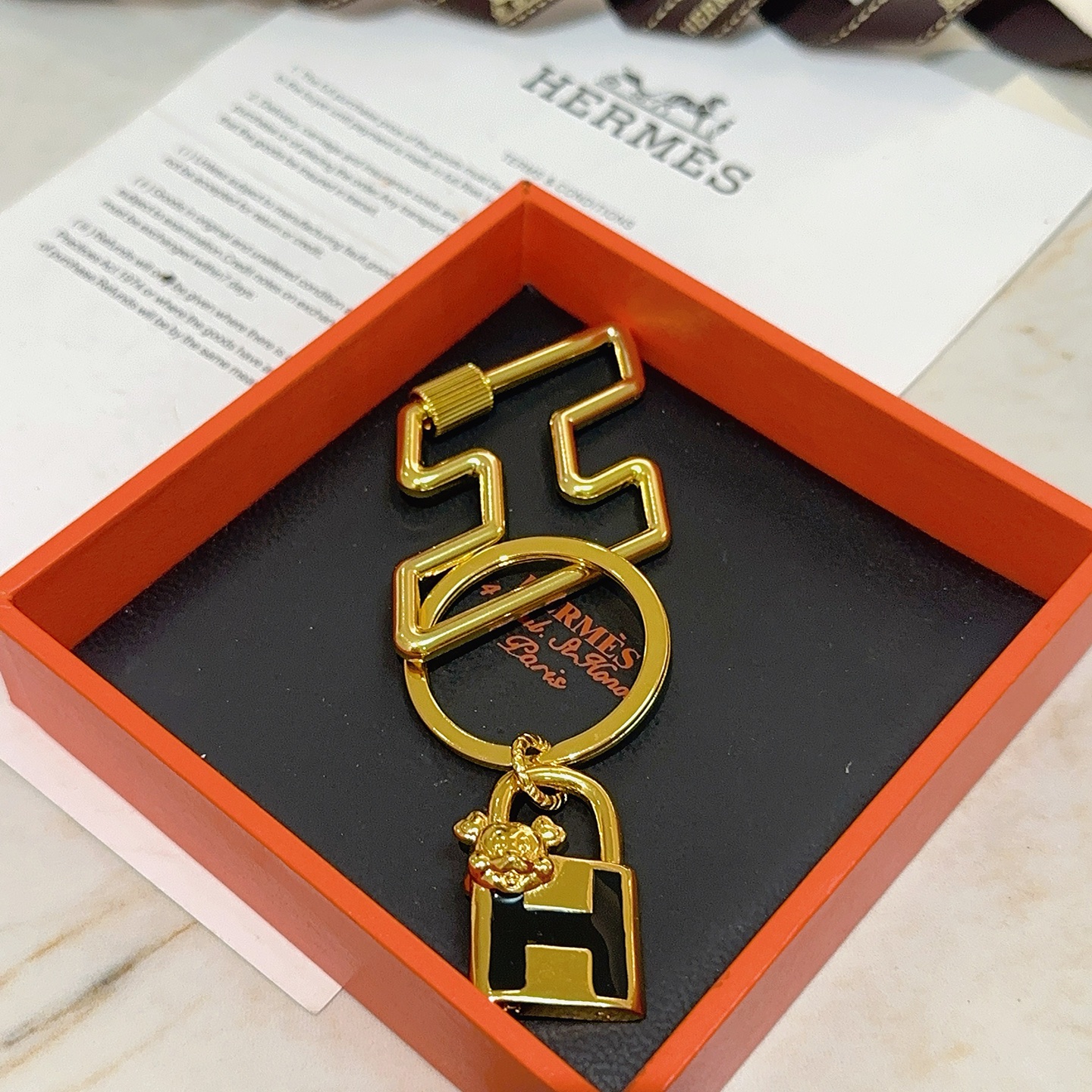 Hermes H Lock Bulldog Charm Keychain pendant gold tone metal with black enamel 8cm total length