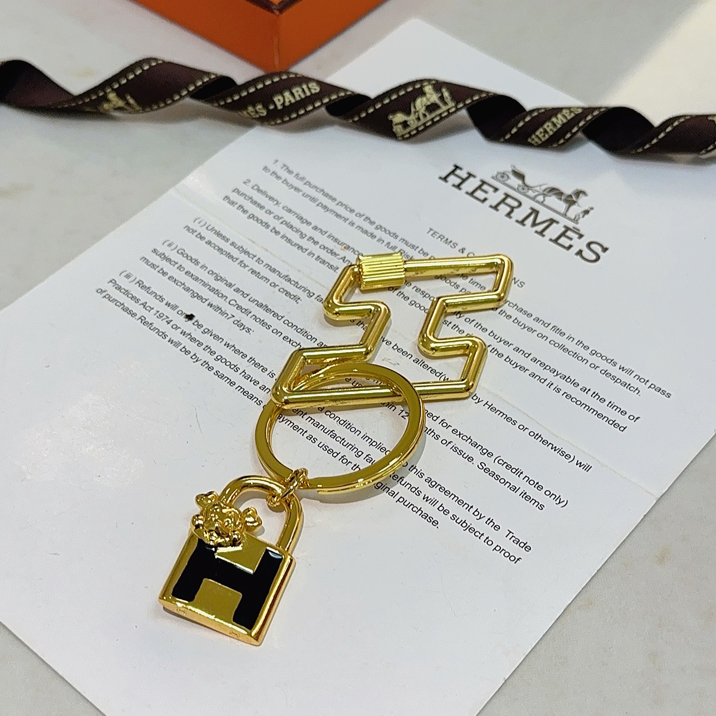Hermes H Lock Bulldog Charm Keychain pendant gold tone metal with black enamel 8cm total length