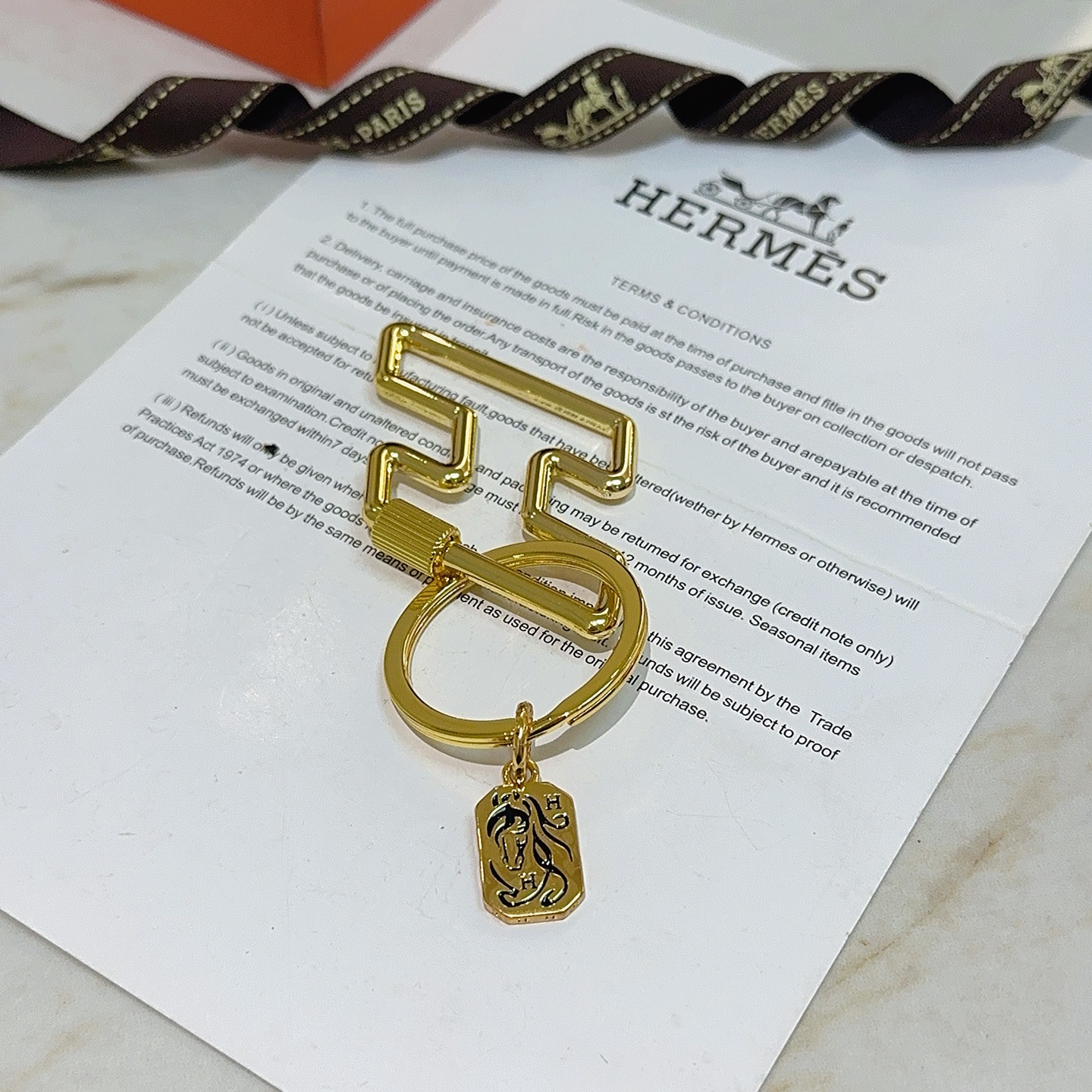 Hermes Cheval Horse Tag Zigzag Key Holder pendant gold tone metal with black enamel detailing 8cm total length