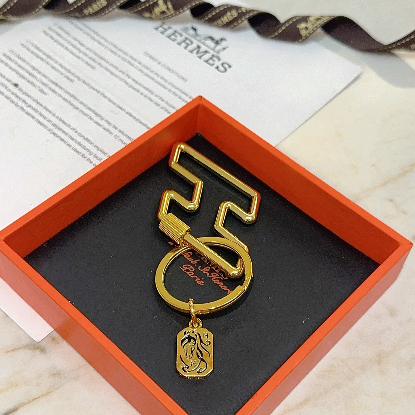 Hermes Cheval Horse Tag Zigzag Key Holder pendant gold tone metal with black enamel detailing 8cm total length