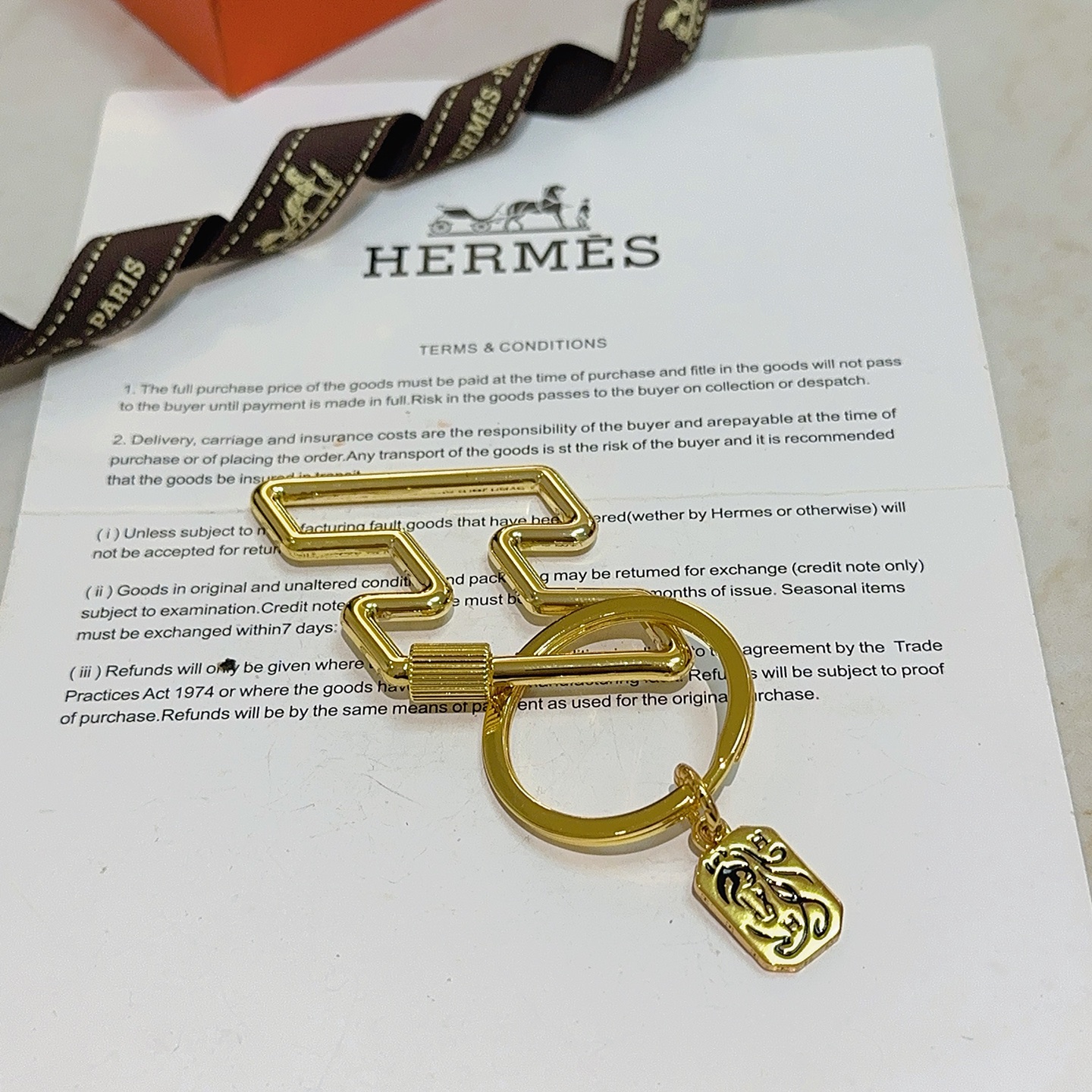 Hermes Cheval Horse Tag Zigzag Key Holder pendant gold tone metal with black enamel detailing 8cm total length