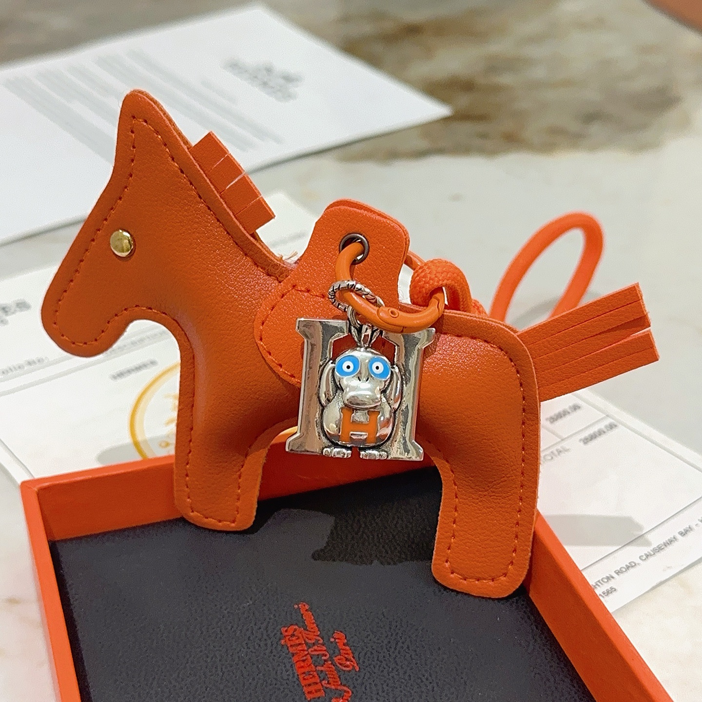 Hermes Rodeo Pegase Horse Charm with H Monkey Pendant pendant Orange leather with silver-tone metal blue and orange enamel accents gold-tone rivet 8cm