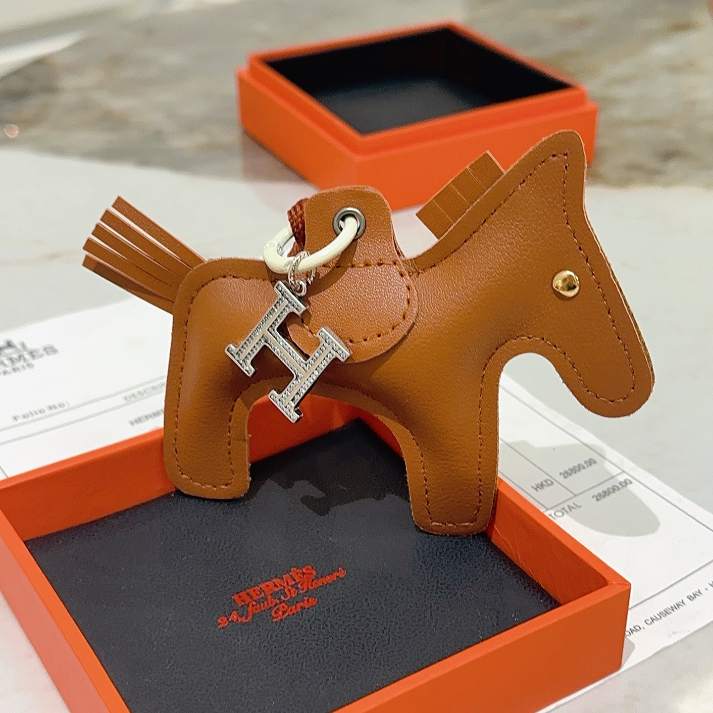 Hermes Rodeo Pegase Horse Bag Charm with H Pendant pendant Gold brown leather silver-tone metal with clear crystal pave H charm gold-tone metal rivet off-white hardware brown woven cord strap 10cm total charm length 8cm