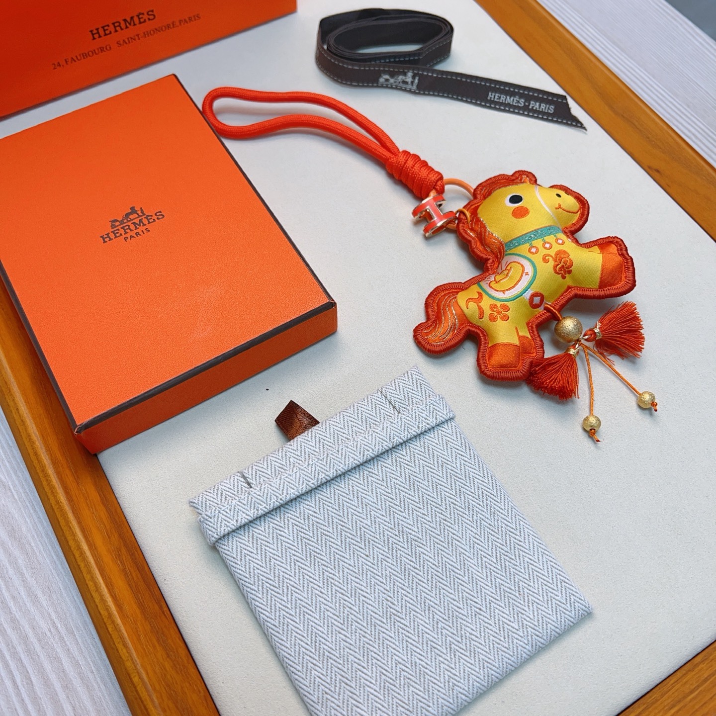Hermes Year of the Horse Charm Keychain pendant Orange enamel H hardware yellow fabric horse charm with orange embroidery orange cord strap gold tone metal beads orange tassels 12cm strap length