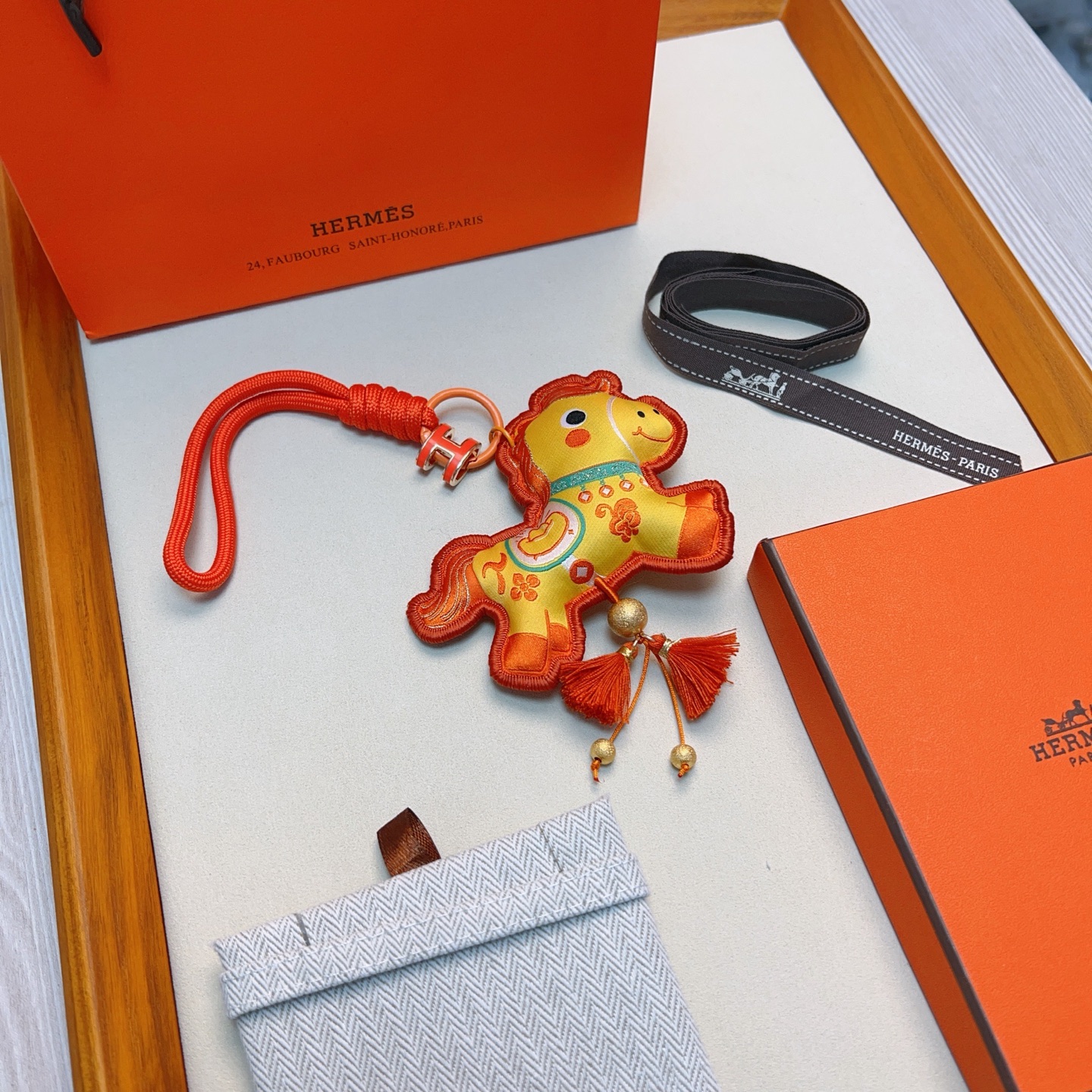 Hermes Year of the Horse Charm Keychain pendant Orange enamel H hardware yellow fabric horse charm with orange embroidery orange cord strap gold tone metal beads orange tassels 12cm strap length