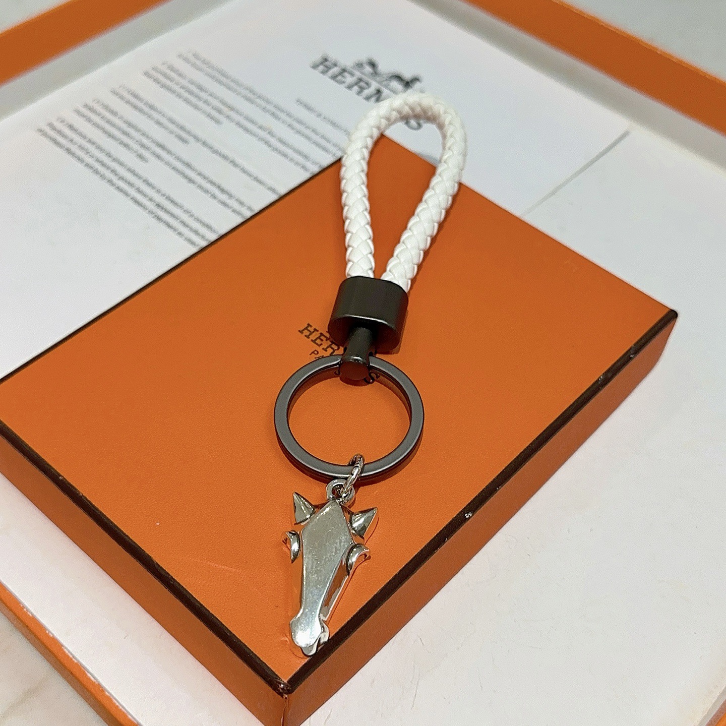 Hermes Horse Head Braided Strap Keychain pendant White braided leather gunmetal gray hardware silver-tone horse head charm 10cm