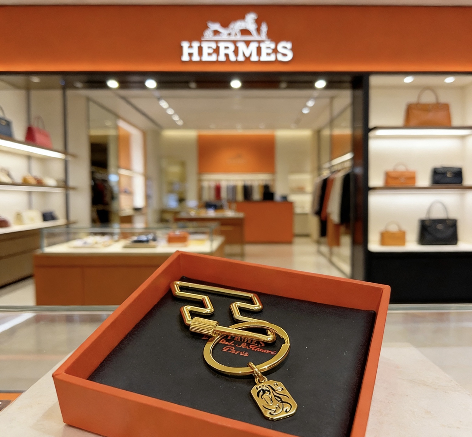 Hermes Horse Head Charm Keychain pendant gold-tone metal with black enamel detailing 3 5cm key ring 7cm zigzag clip