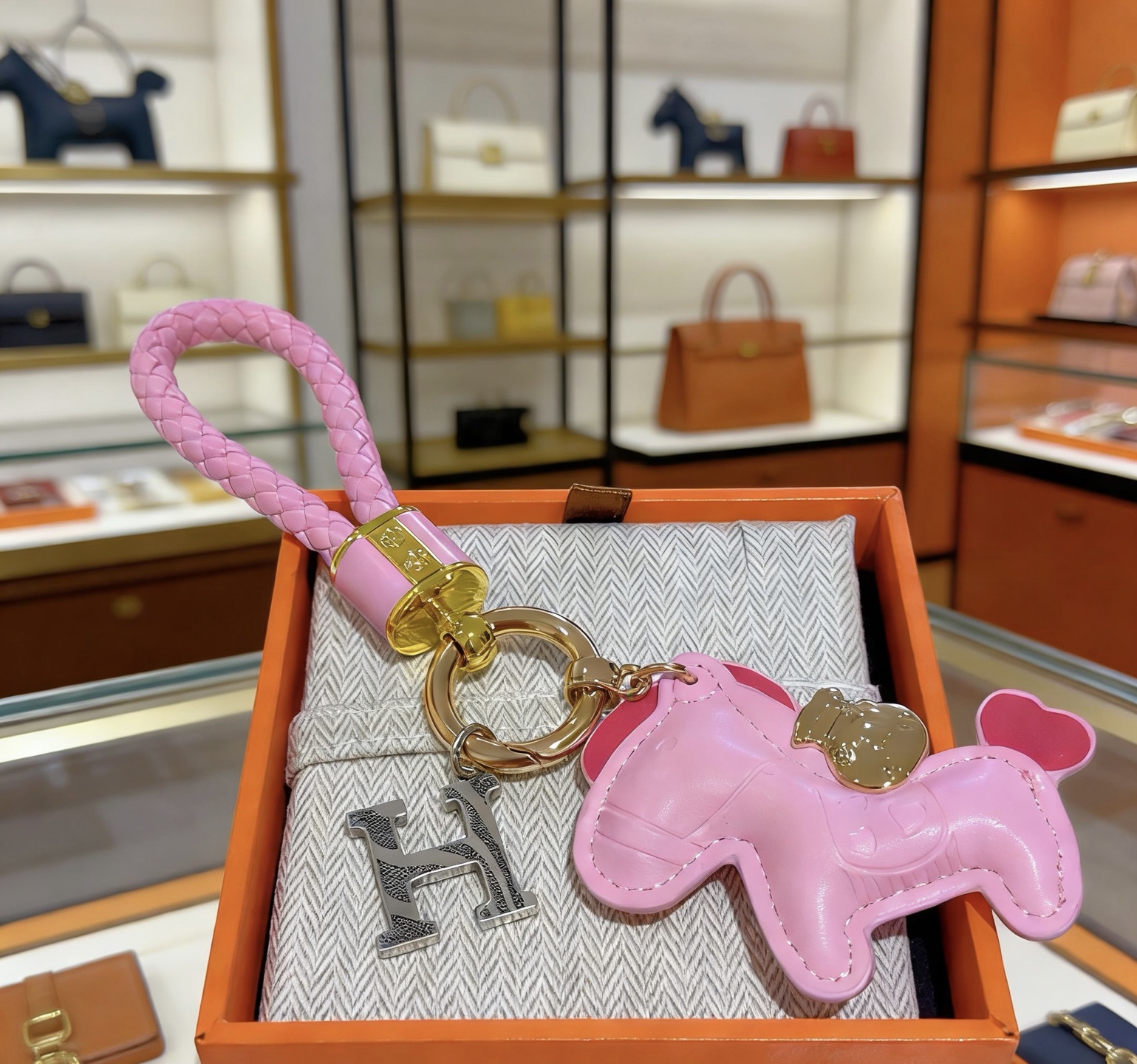 Hermes Rodeo Pony H Charm Keychain pendant Pink braided leather gold-tone metal hardware silver-tone H charm pink leather pony charm with red heart tail detail 10cm total length