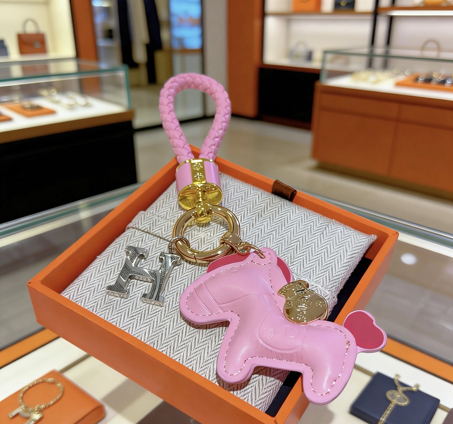 Hermes Rodeo Pony H Charm Keychain pendant Pink braided leather gold-tone metal hardware silver-tone H charm pink leather pony charm with red heart tail detail 10cm total length