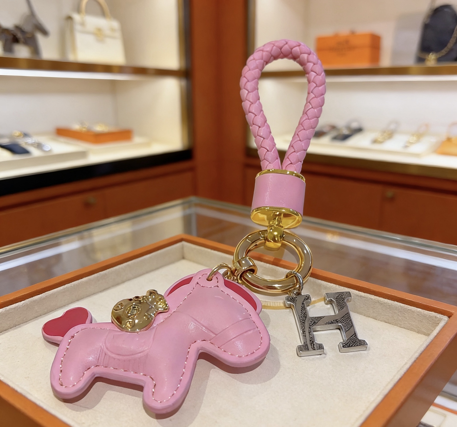 Hermes Rodeo Pony H Charm Keychain pendant Pink braided leather gold-tone metal hardware silver-tone H charm pink leather pony charm with red heart tail detail 10cm total length