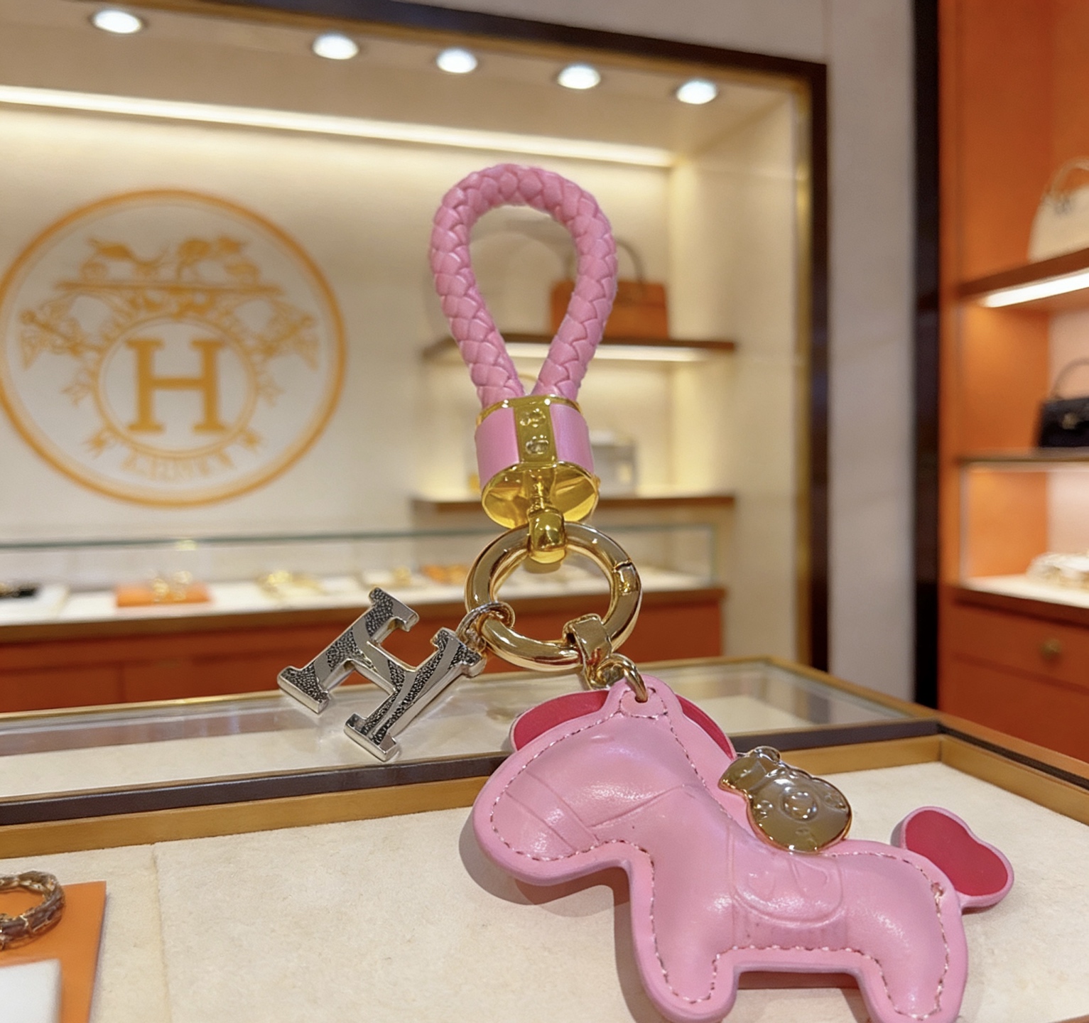 Hermes Rodeo Pony H Charm Keychain pendant Pink braided leather gold-tone metal hardware silver-tone H charm pink leather pony charm with red heart tail detail 10cm total length