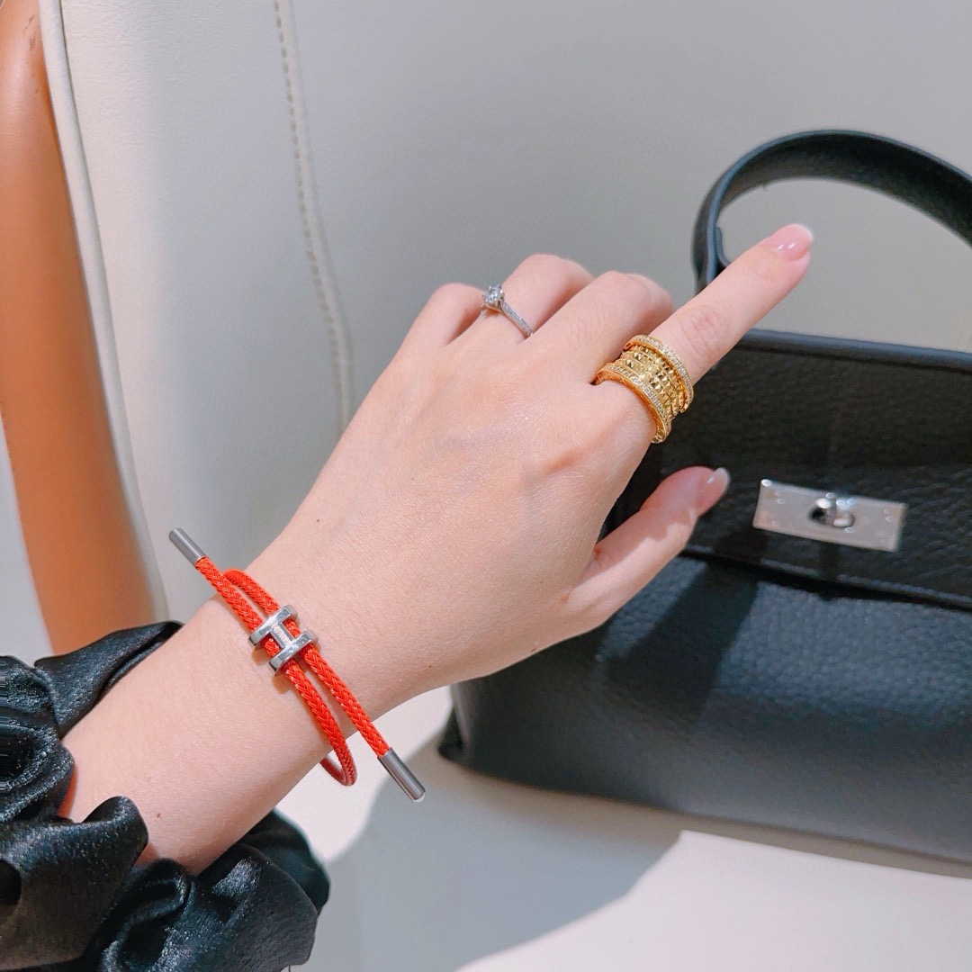 Hermes Tournis Tresse H bracelet Orange braided cord with silver-tone palladium plated H clasp and end caps Adjustable sliding design fits wrist sizes approximately 15cm to 19cm