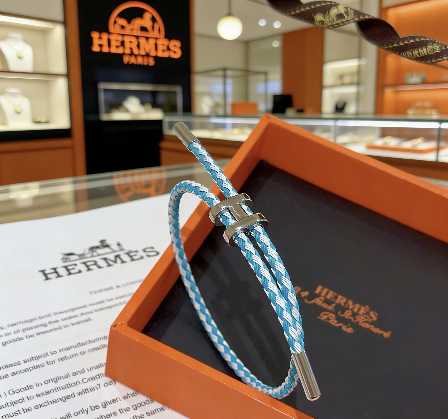 Hermes Tournis Tresse bracelet palladium silver hardware turquoise blue and white braided cord adjustable sliding closure fits 15-18cm wrist