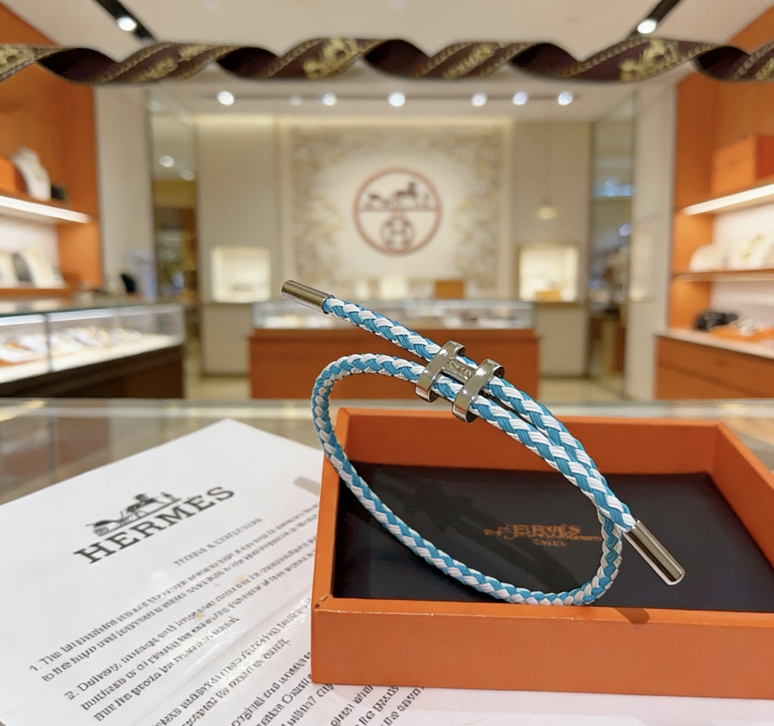Hermes Tournis Tresse bracelet palladium silver hardware turquoise blue and white braided cord adjustable sliding closure fits 15-18cm wrist