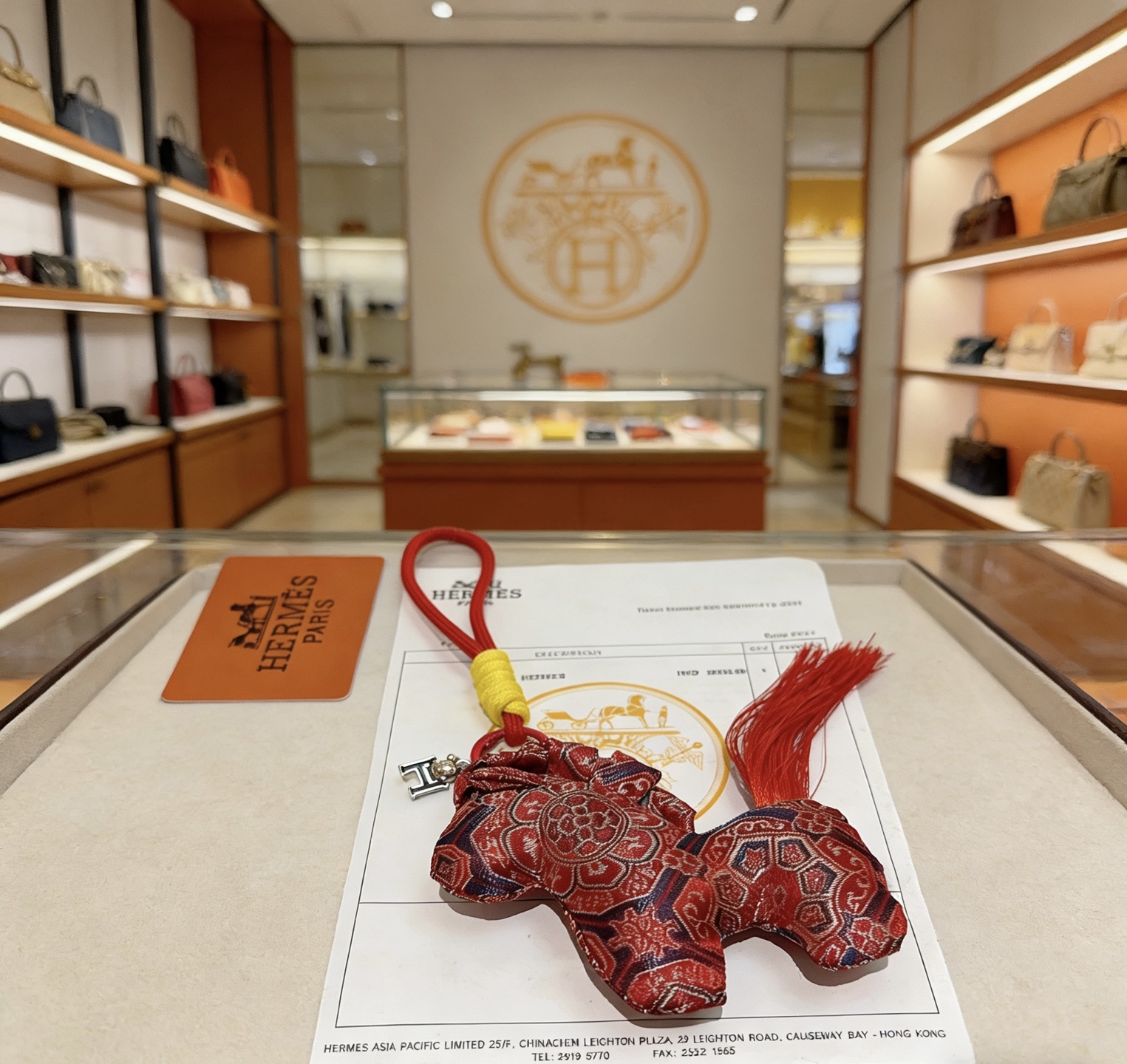 Hermes Rodeo Horse Charm pendant Red fabric with navy and gold traditional patterns red cord yellow cord wrap silver-tone H charm red tassel 8cm