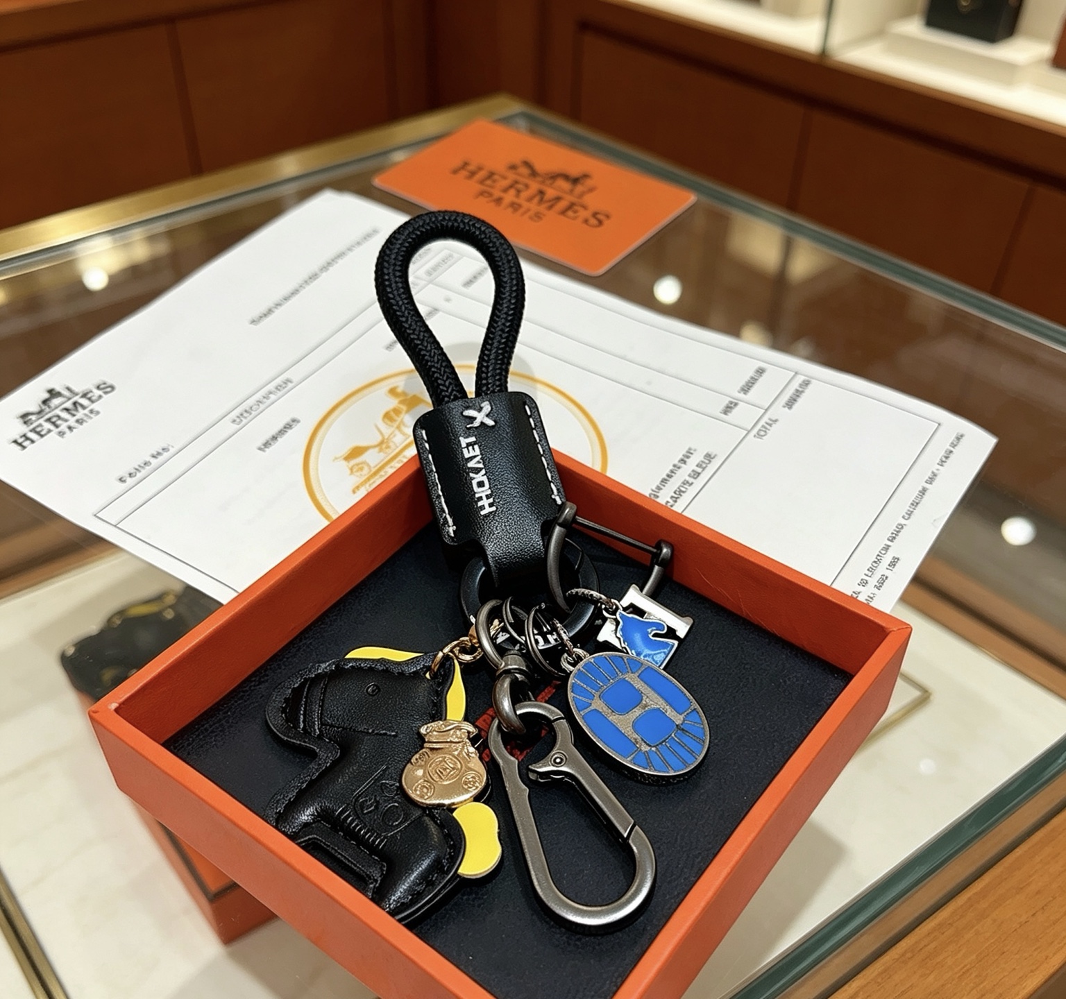 Hermes Rodeo Horse Charm Keychain pendant Black leather gunmetal hardware blue enamel yellow leather accent gold-tone charm 12cm total length