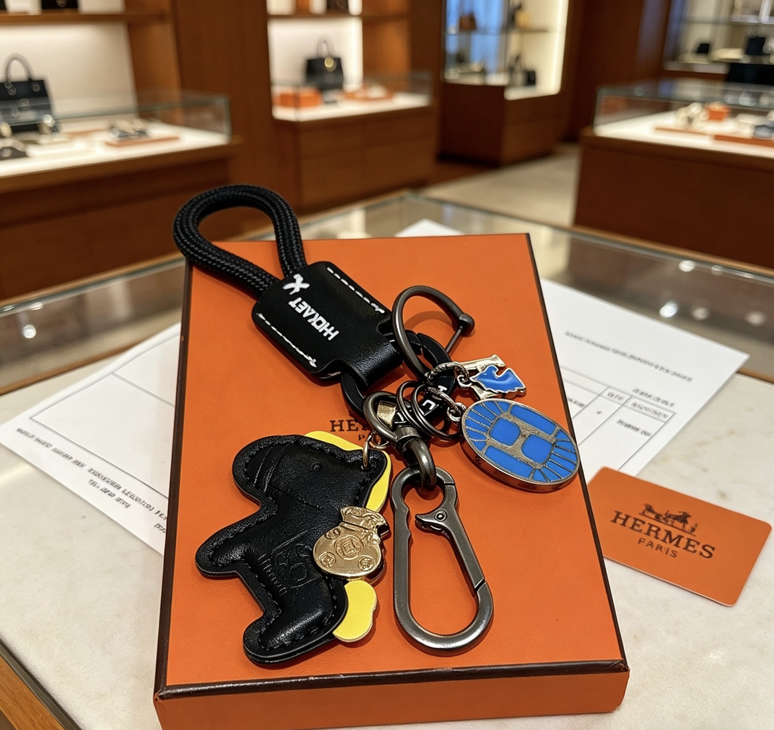 Hermes Rodeo Horse Charm Keychain pendant Black leather gunmetal hardware blue enamel yellow leather accent gold-tone charm 12cm total length