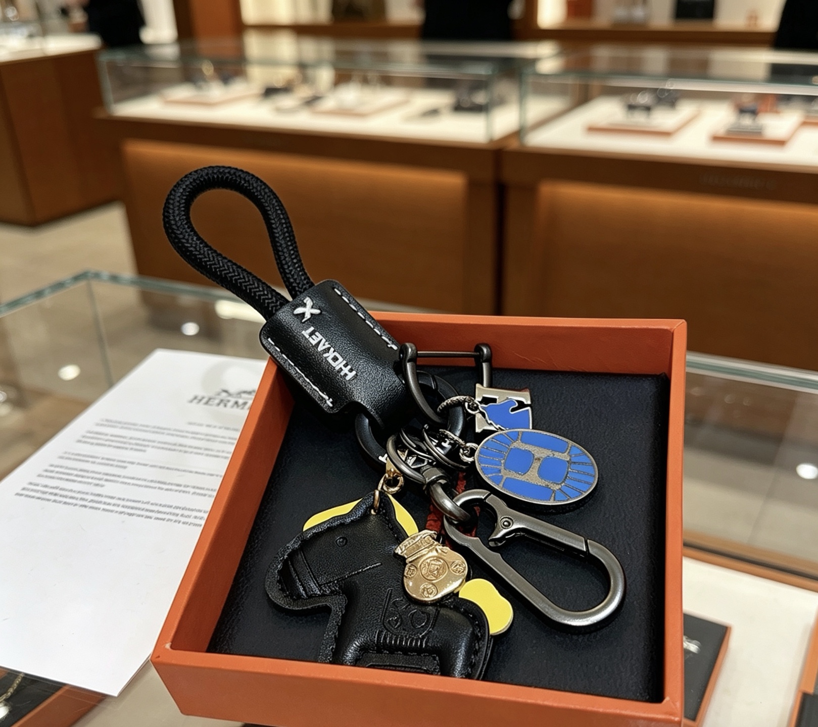 Hermes Rodeo Horse Charm Keychain pendant Black leather gunmetal hardware blue enamel yellow leather accent gold-tone charm 12cm total length
