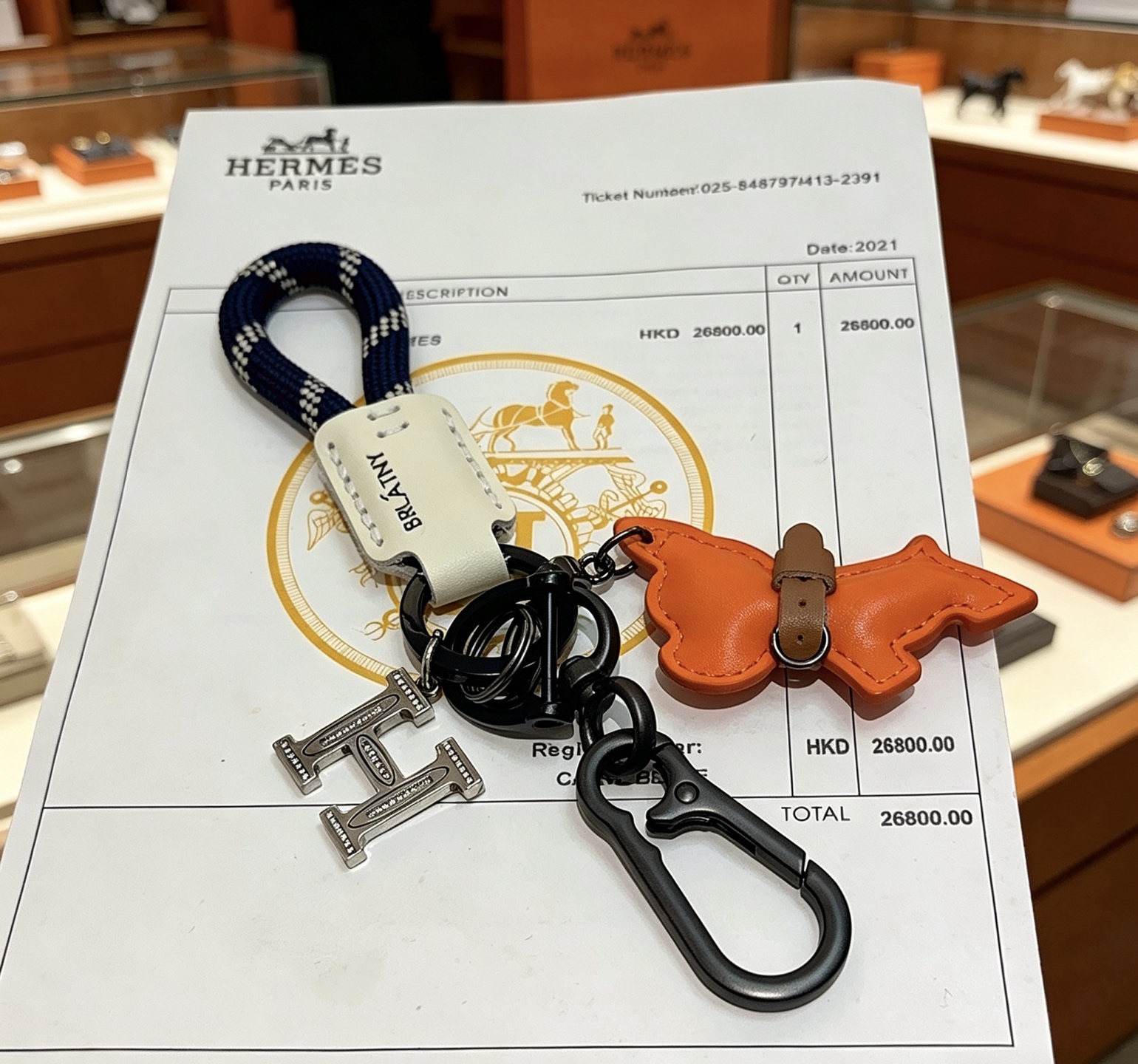 Hermes BRLATNY Puppy H Charm Keychain pendant Gunmetal black hardware orange leather puppy charm off-white leather tag navy blue with white woven rope brown leather collar detail 12cm total length