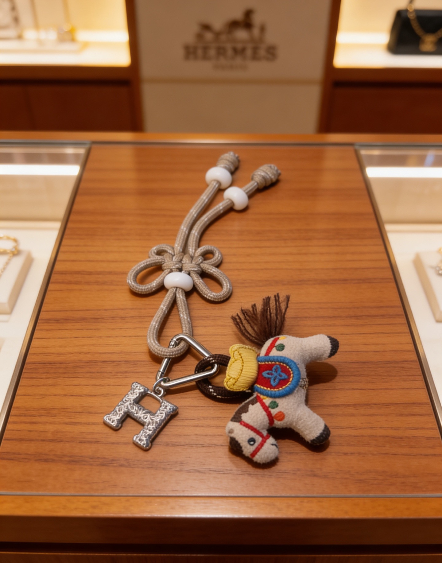 Hermes Rodeo Pegase Horse H Charm Keychain pendant Silver-tone metal beige felt with multicolor embroidery beige cord with white beads brown felt tail 12cm total length