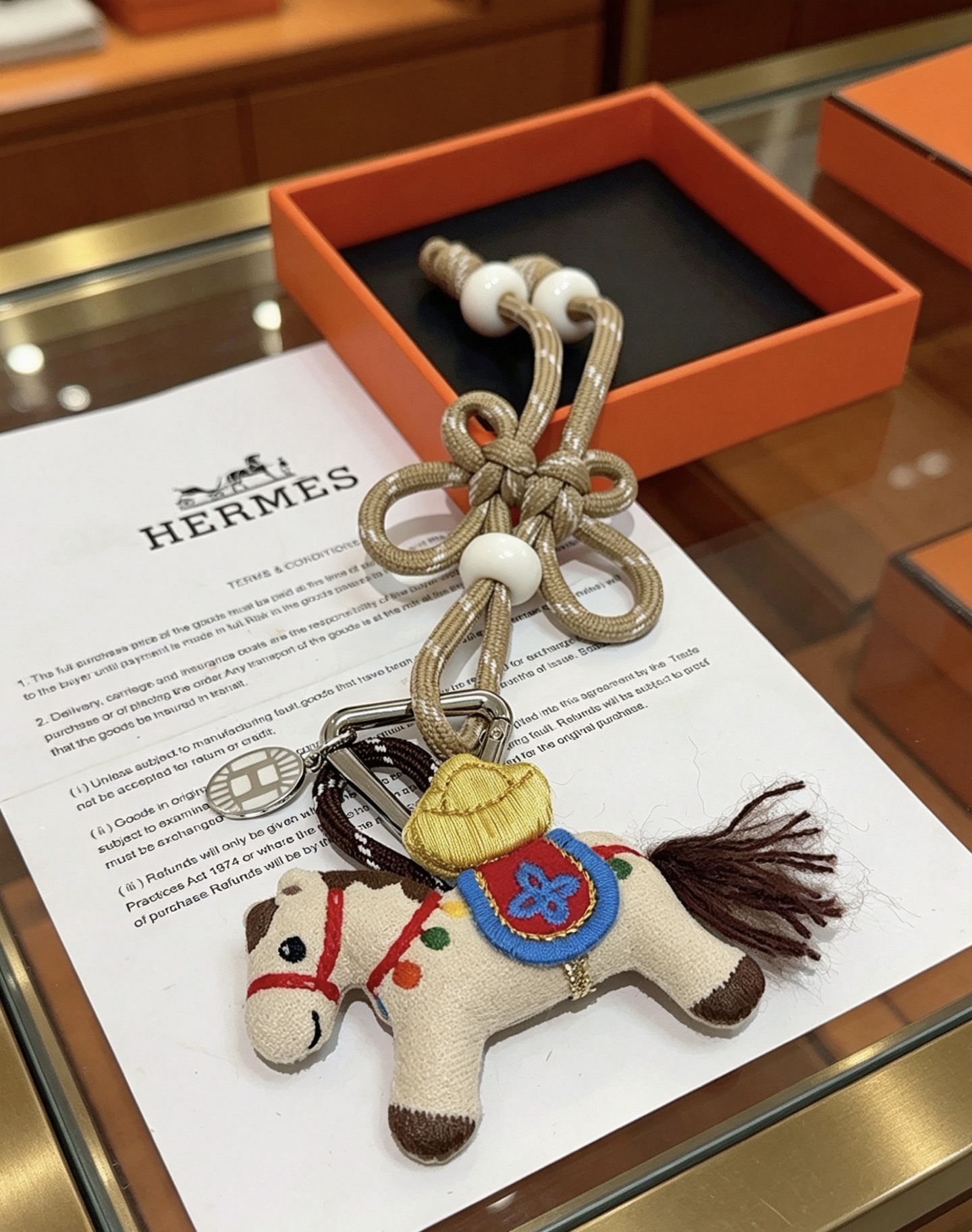 Hermes Rodeo Chinese Knot Horse Charm pendant palladium silver metal beige fabric horse with multicolor embroidery champagne gold woven cord with white resin beads 12cm total length