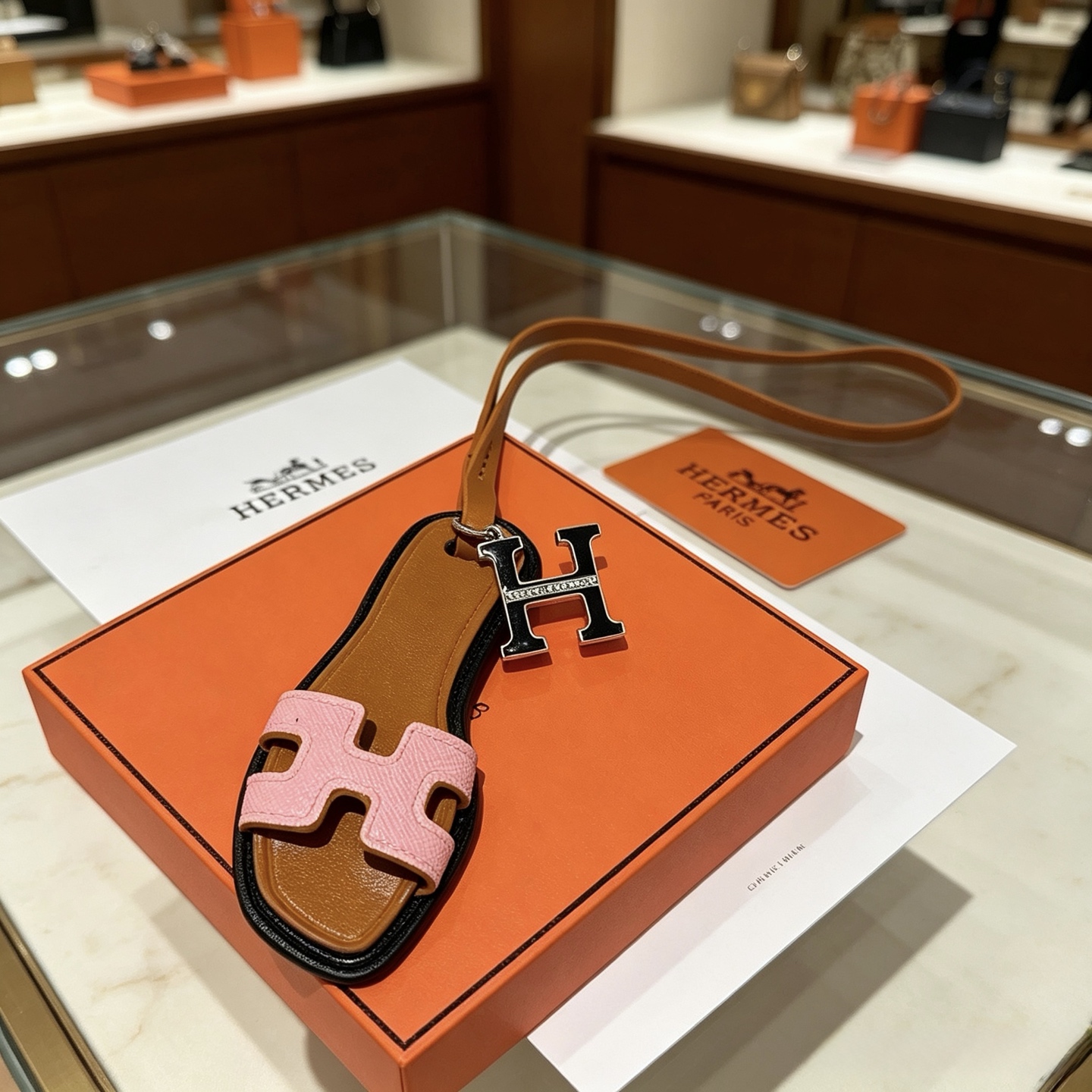 Hermes Oran Sandal Bag Charm pendant Brown black pink leather with silver-tone metal and clear diamond-like accent stones 12cm charm with 40cm leather strap