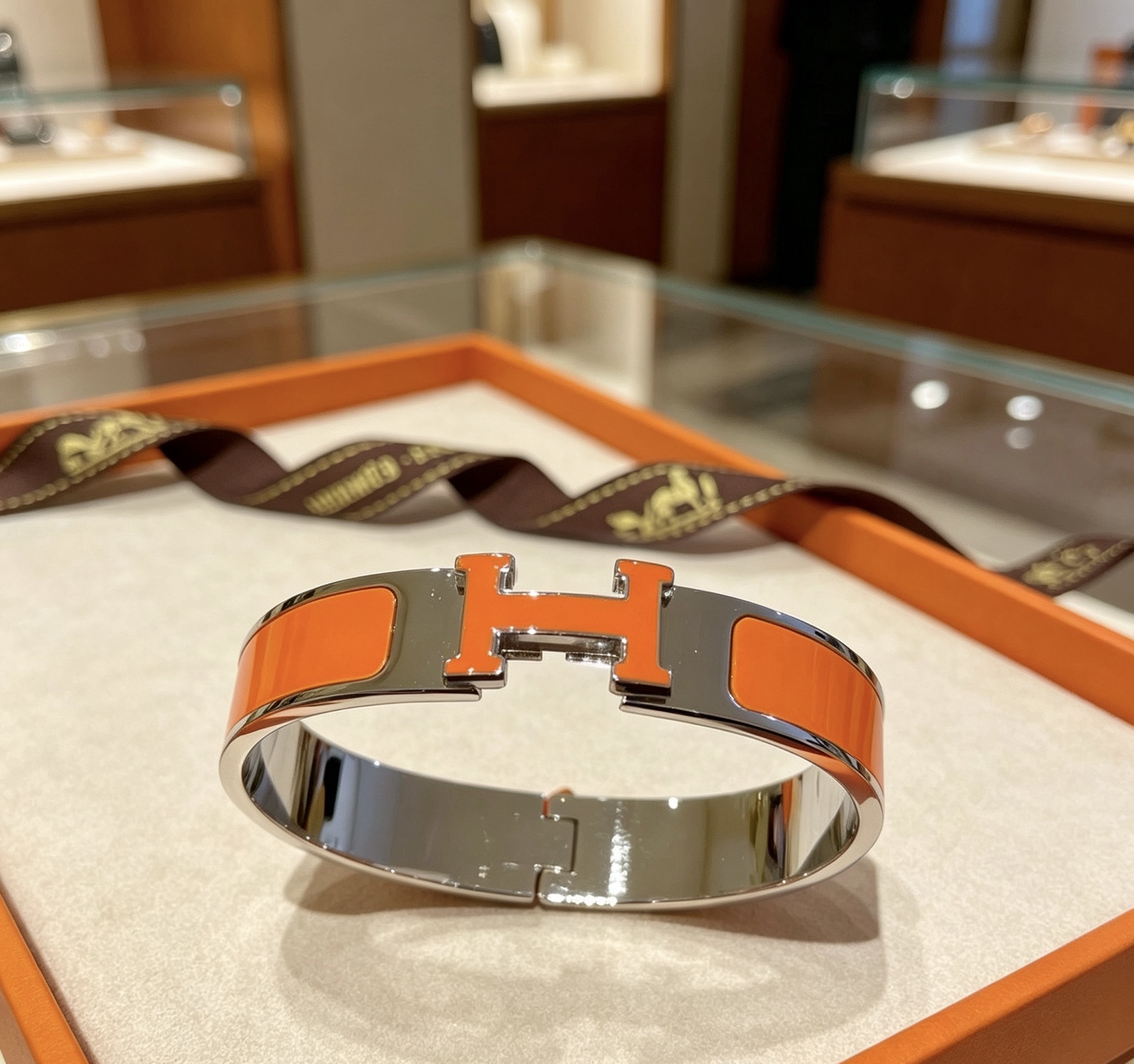 Pulsera Hermes Clic H metal plateado paladio esmalte naranja PM